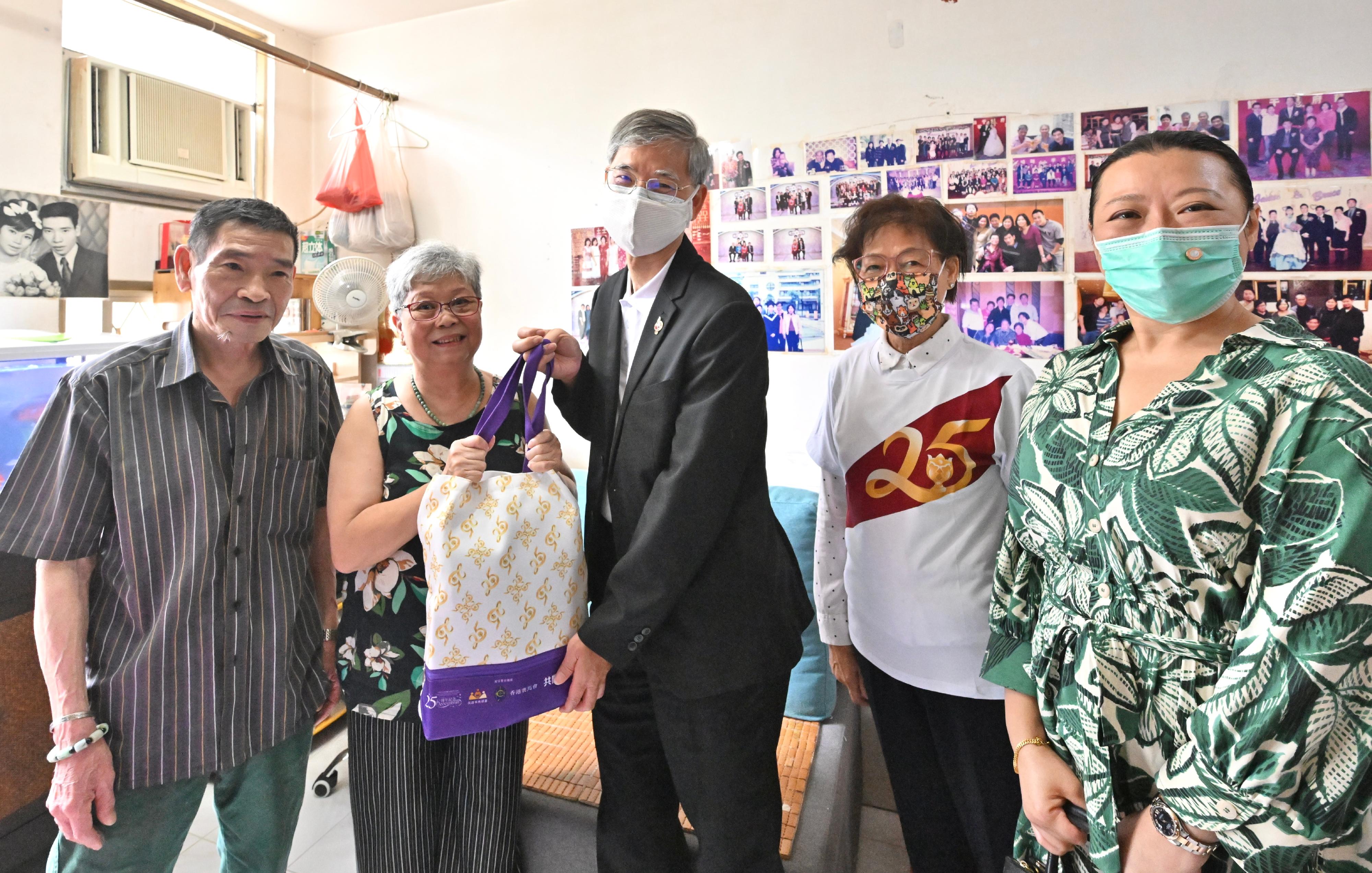 The Secretary for Labour and Welfare, Dr Law Chi-kwong, today (June 20) visited Wan Chai District and Islands District, and distributed gift packs under the Celebrations for All project in celebration of the 25th anniversary of the establishment of the Hong Kong Special Administrative Region, extending warm regards to the disadvantaged and the underprivileged. Photo shows (from third left) Dr Law; the Chairman of the OIWA, Ms Chau Chuen-heung; and the District Officer (Islands), Miss Amy Yeung, in a visit to elderly doubletons in Tung Chung, encouraging them to make good use of anti-epidemic supplies for personal protection during festive celebrations.