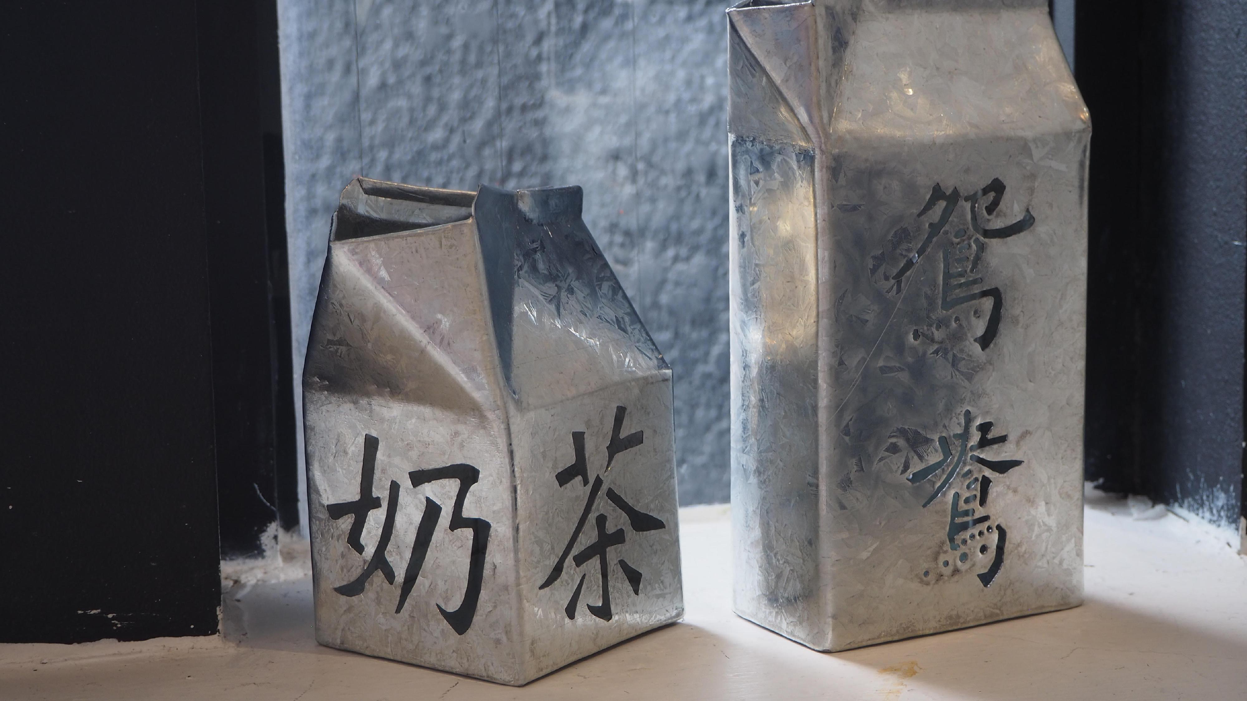 The opening ceremony of the "Beyond Borders: Traces of Hong Kong Stories" art exhibition was held at CF Richmond Centre in Vancouver yesterday (June 22, Vancouver time). Photo shows galvanised iron milk cartons made by Hong Kong artist Luk Tsing-yuen, demonstrating the galvanised iron product making technique, a recognised craft of Hong Kong’s Intangible Cultural Heritage.