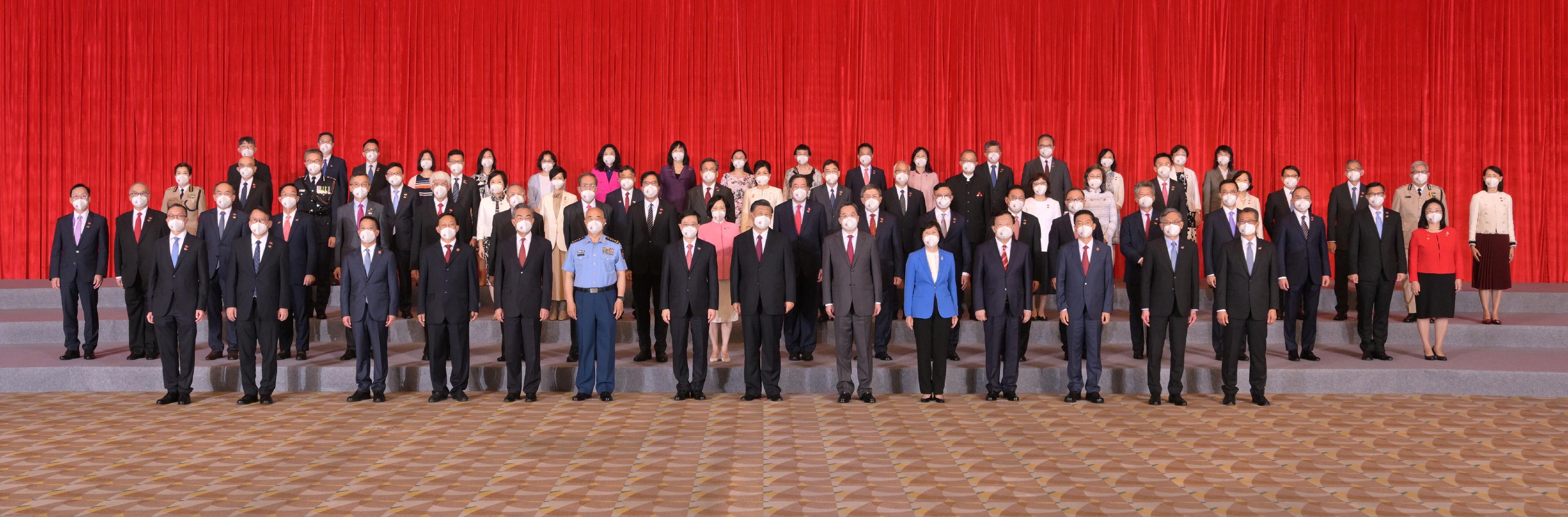 President Xi Jinping (seventh right) is pictured with the new Chief Executive, Mr John Lee (seventh left), and members of the executive, the legislature and the judiciary today (July 1).