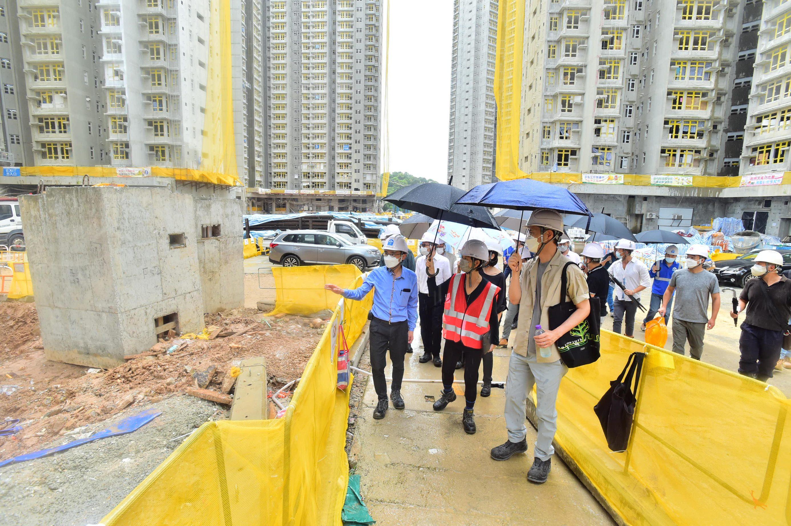 The Secretary for Housing, Ms Winnie Ho, visited Tai Po Area 9 this morning (July 7) to grasp the latest progress of the public rental housing development projects. Photo shows Ms Ho (front, centre), accompanied by staff members of the Housing Department, touring Fu Tip Estate, which is under construction.