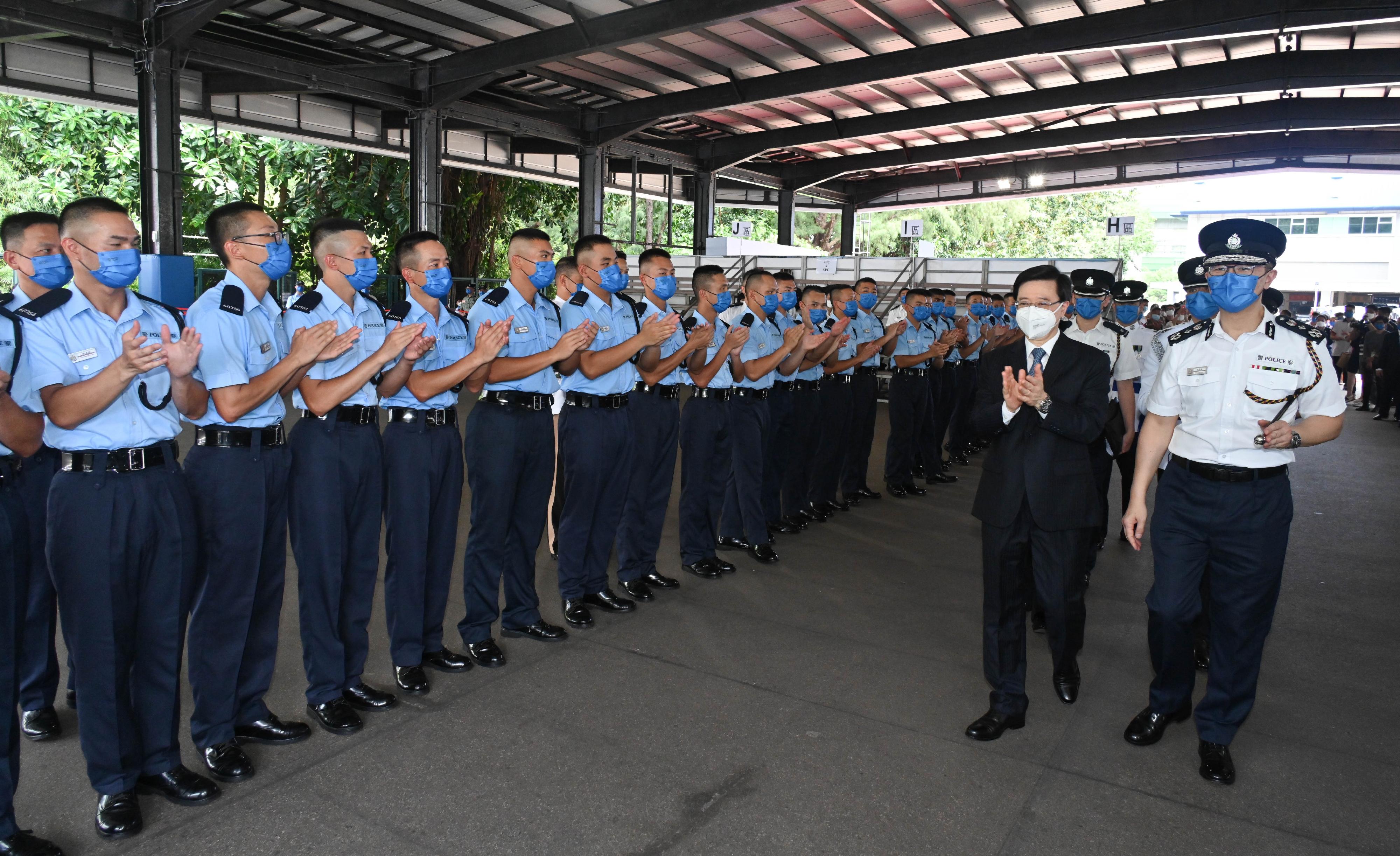 The Chief Executive, Mr John Lee (second right), accompanied by the Commissioner of Police, Mr Siu Chak-yee (first right), meets graduates after the passing-out parade held at the Hong Kong Police College today (July 9).