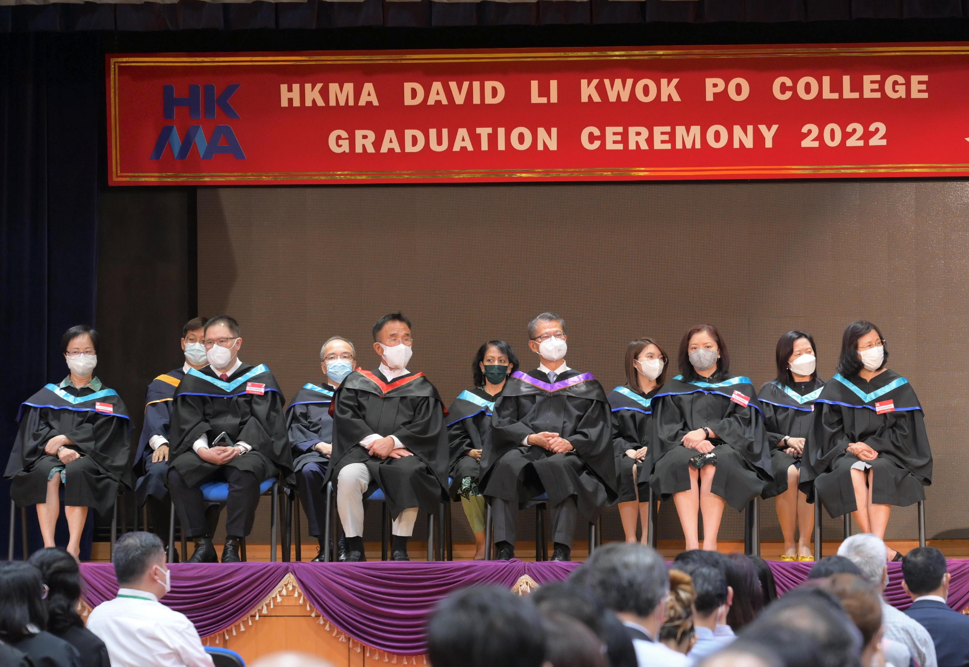 The Financial Secretary, Mr Paul Chan, attended the Hong Kong Management Association David Li Kwok Po College Graduation Ceremony 2022 today (July 9).  Photo shows Mr Chan (first row, third right); Chairman of the Incorporated Management Committee (IMC) of the college, Mr Michael Tien (first row, third left); and members of the IMC of the college.