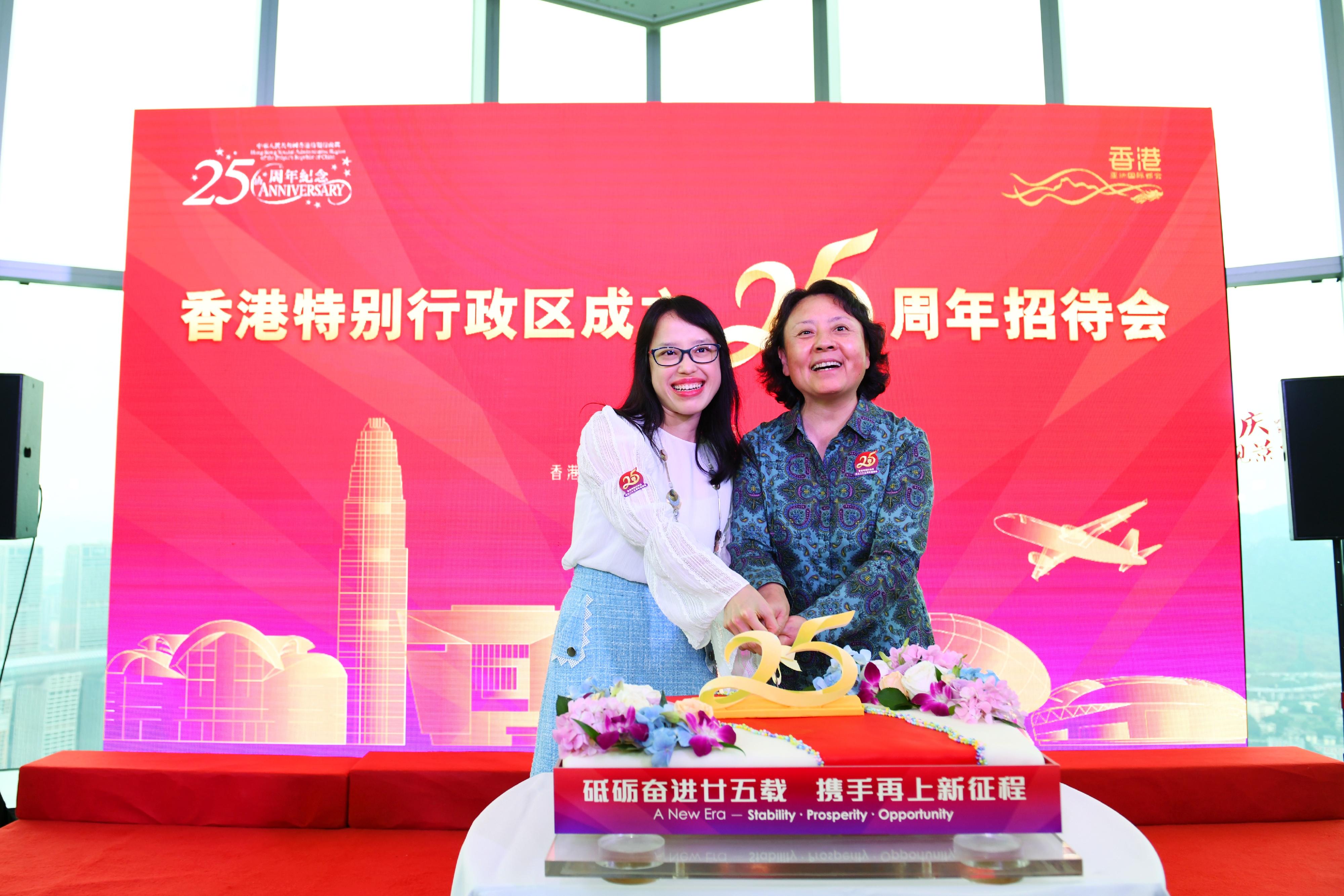 The Hong Kong Economic and Trade Office in Chengdu (CDETO) of the Government of the Hong Kong Special Administrative Region (HKSAR) has been holding a series of celebration activities since June to mark the 25th anniversary of the establishment of the HKSAR. Photo shows the Director of the CDETO, Miss Li Wan-in (left), and the Vice Chairman of the Chongqing Municipal Committee of the Chinese People's Political Consultative Conference, Ms Zhang Ling (right), cutting a cake at a reception in Chongqing on July 1.
