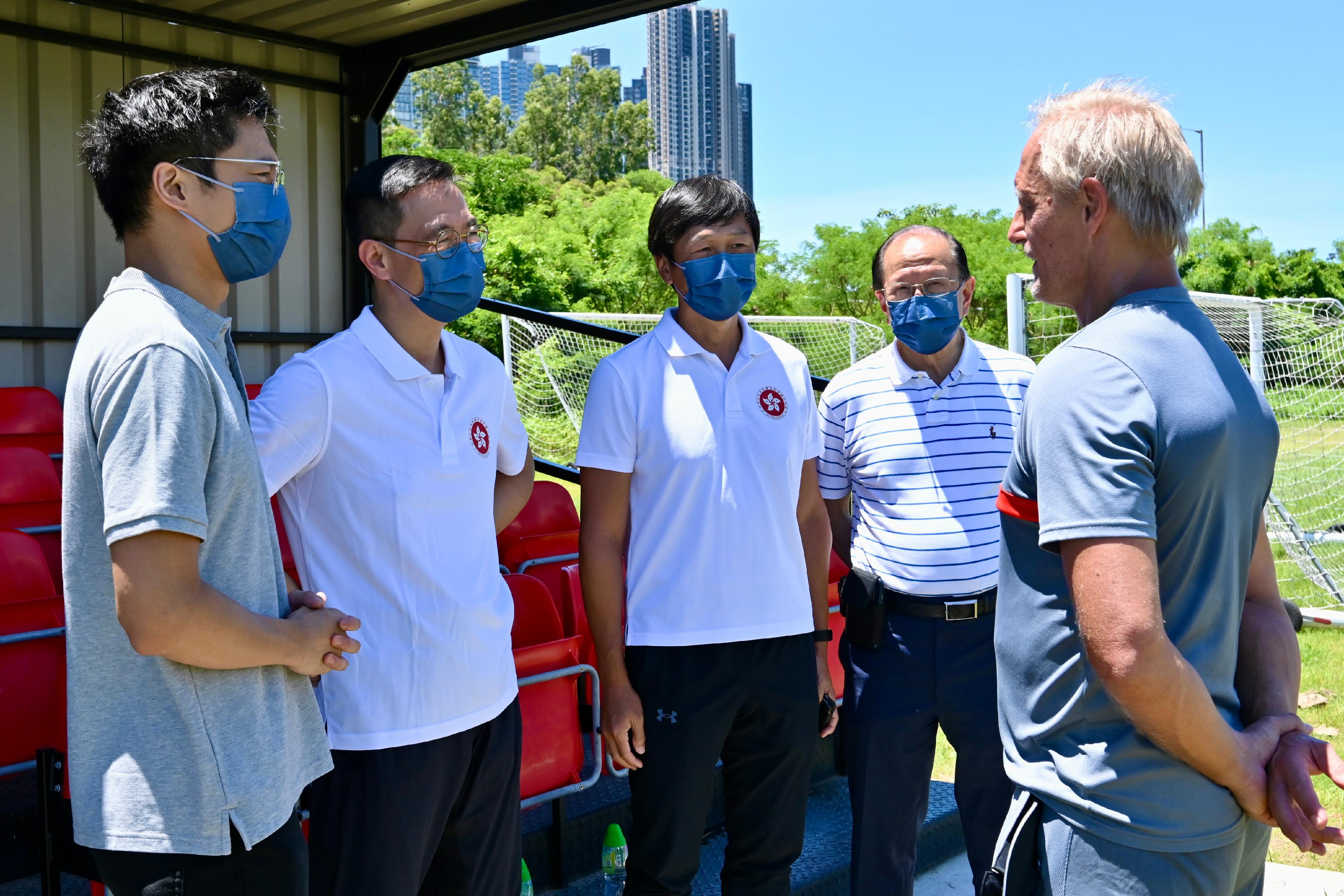 The Secretary for Culture, Sports and Tourism, Mr Kevin Yeung, visited the Jockey Club Hong Kong Football Association Football Training Centre today (July 13). Photo shows Mr Yeung (second left) chatting with the Head Coach, Mr Jörn Andersen (first right), to learn about the training of the Hong Kong football team.