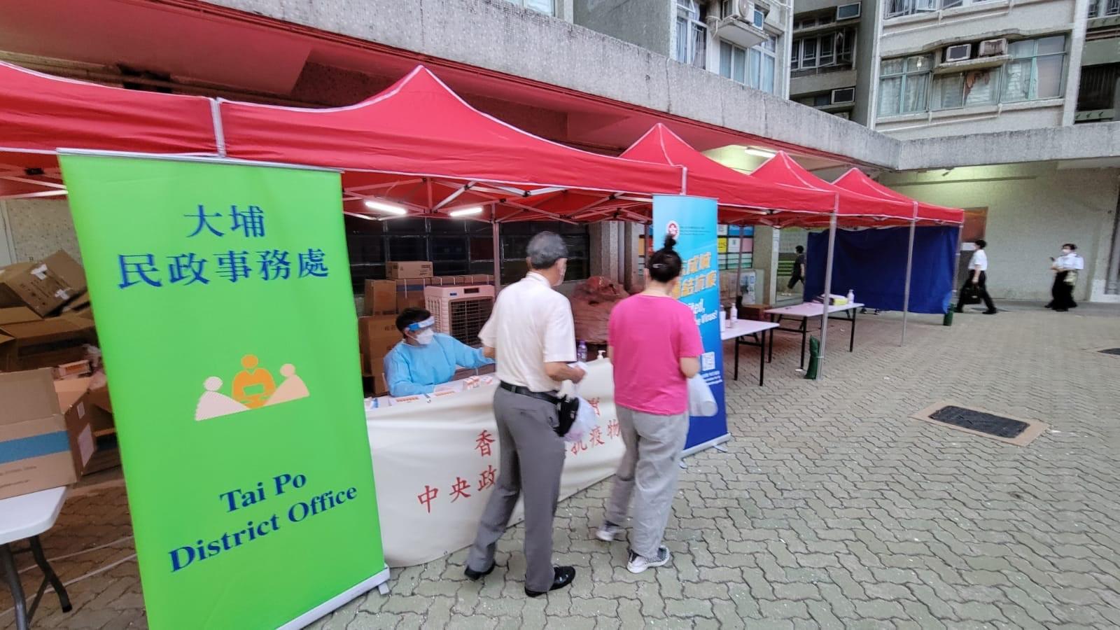 The Government yesterday (July 15) made a "restriction-testing declaration" and issued a compulsory testing notice in respect of the specified "restricted area" in Tai Po (i.e. Chung Chun House, Chung Nga Court, Tai Po, excluding the non-domestic units on G/F), under which people within the specified "restricted area" in Tai Po were required to stay in their premises and undergo compulsory testing. Photo shows the staff distributing anti-epidemic proprietary Chinese medicines donated by the Central People's Government or procured with the co-ordination of the Central People's Government to persons subject to compulsory testing in the "restricted area".
