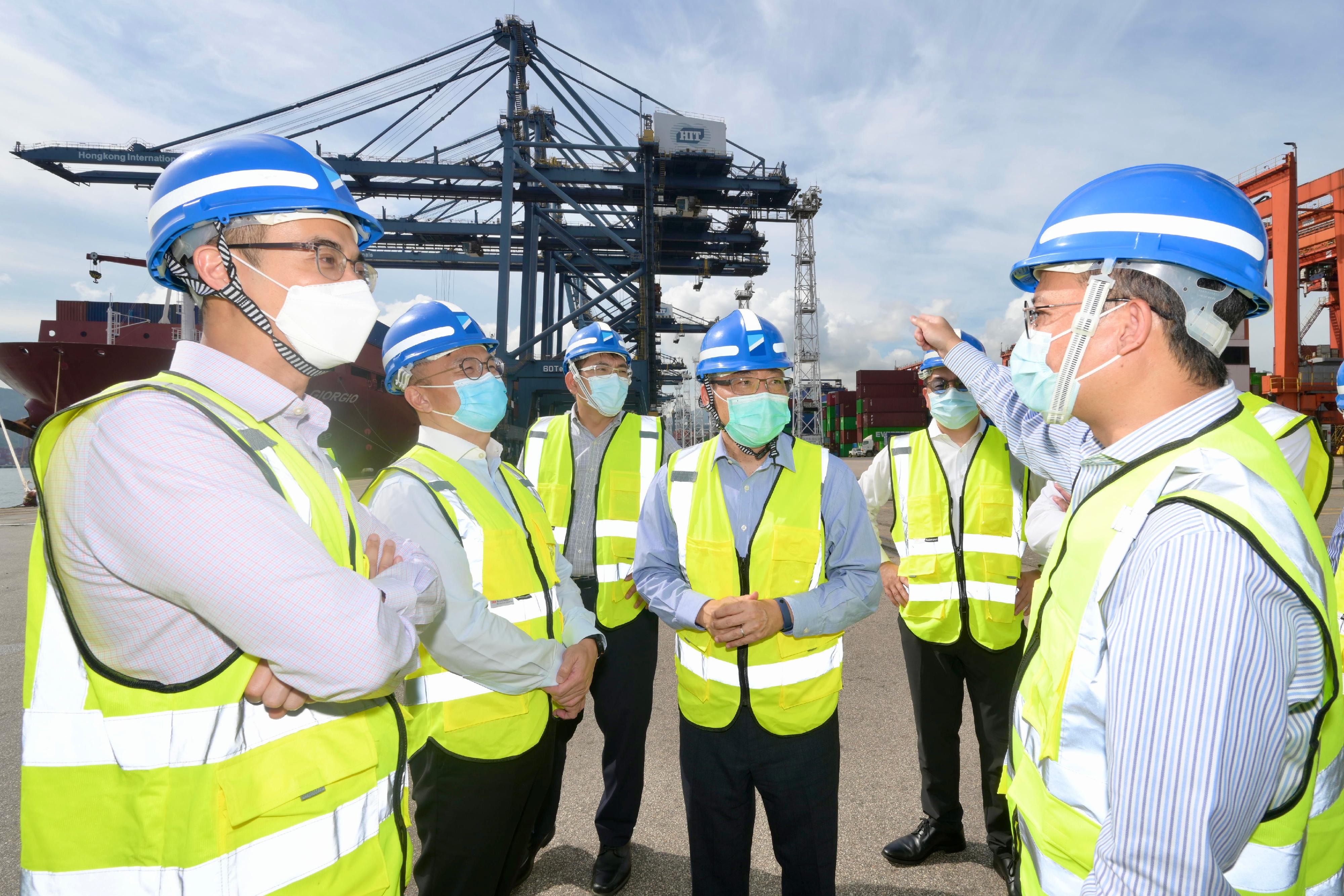 The Secretary for Transport and Logistics, Mr Lam Sai-hung (fourth left), visits the container yard at the Kwai Tsing Container Terminals today (July 19).