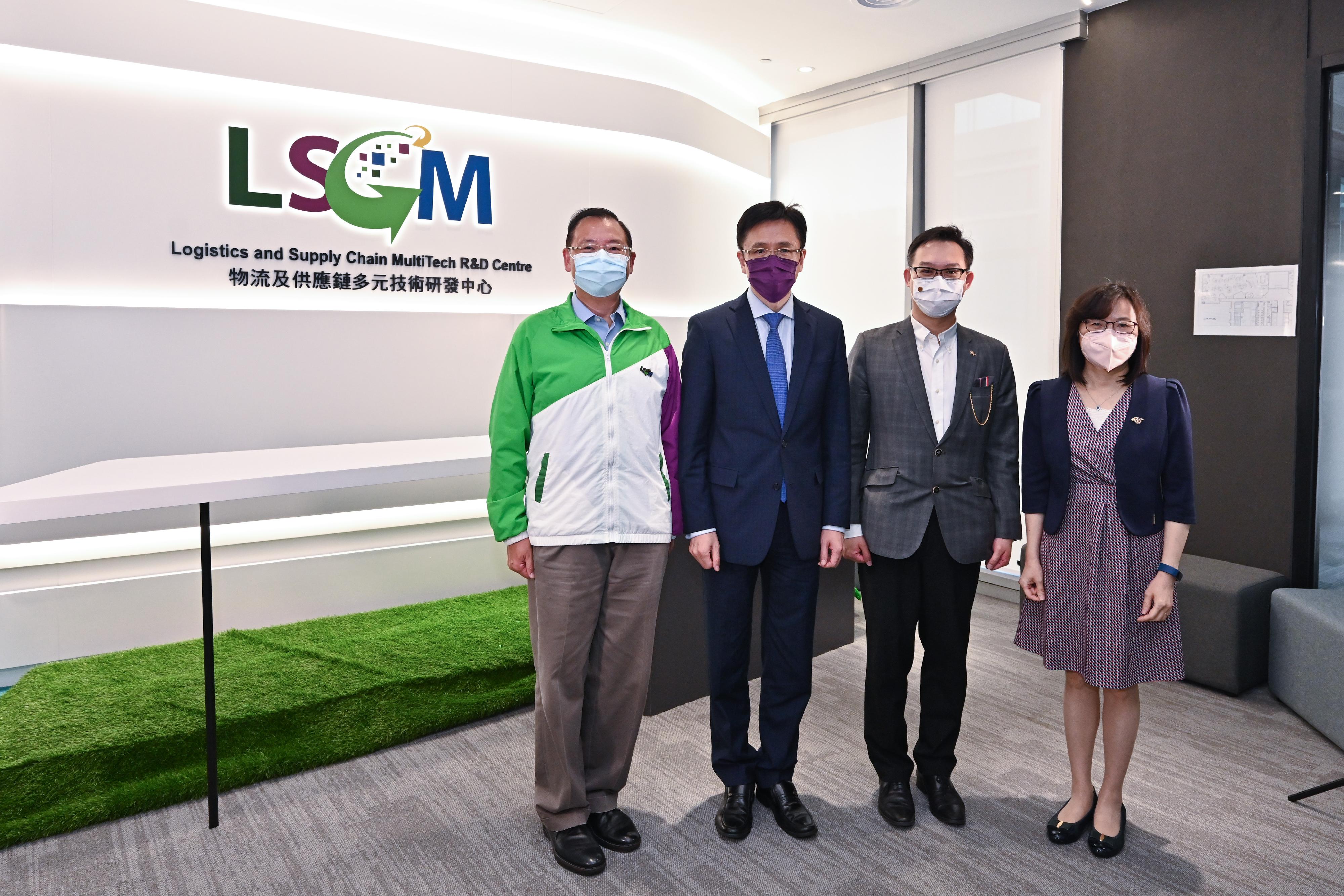 Accompanied by the Commissioner for Innovation and Technology, Ms Rebecca Pun (first right), the Secretary for Innovation, Technology and Industry, Professor Sun Dong (second left), visits the Logistics and Supply Chain MultiTech R&D Centre (LSCM) today (July 19) and is pictured with the Chairman of the LSCM, Dr Alan Lam (second right), and the Chief Executive Officer of the LSCM, Mr Simon Wong (first left).