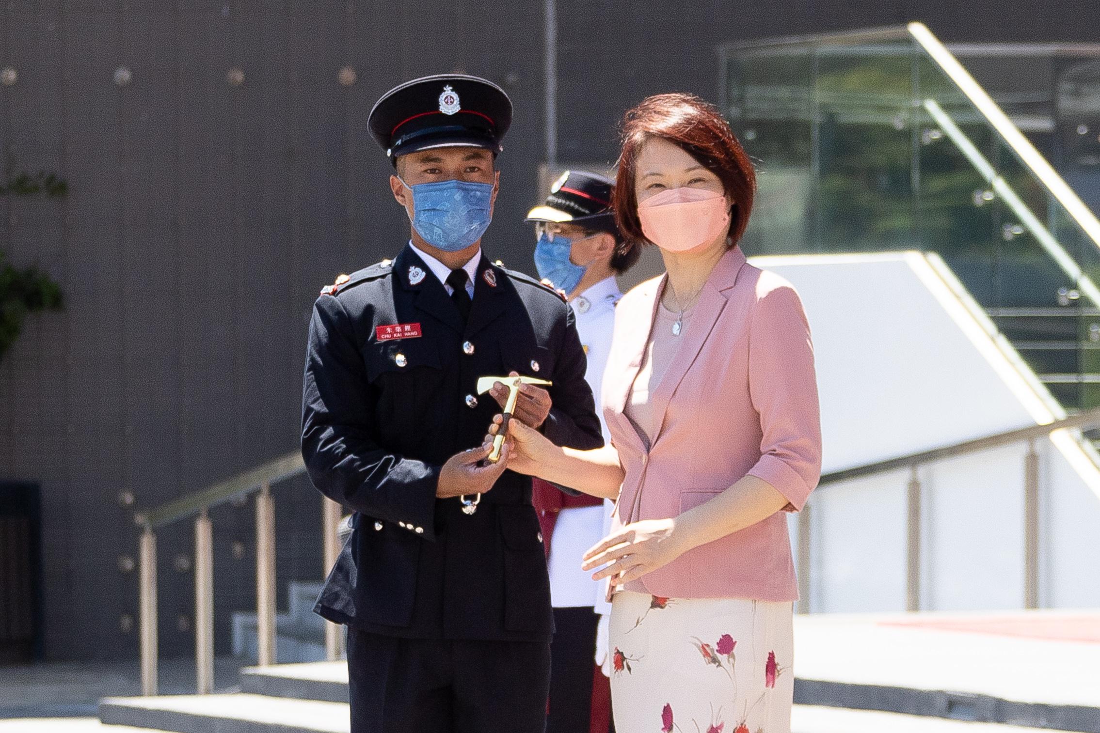 Member of the Legislative Council, Ms Starry Lee, reviewed the Fire Services passing-out parade at the Fire and Ambulance Services Academy today (July 22). Photo shows Ms Lee (right) presenting the Best Recruit Station Officer award to a graduate.