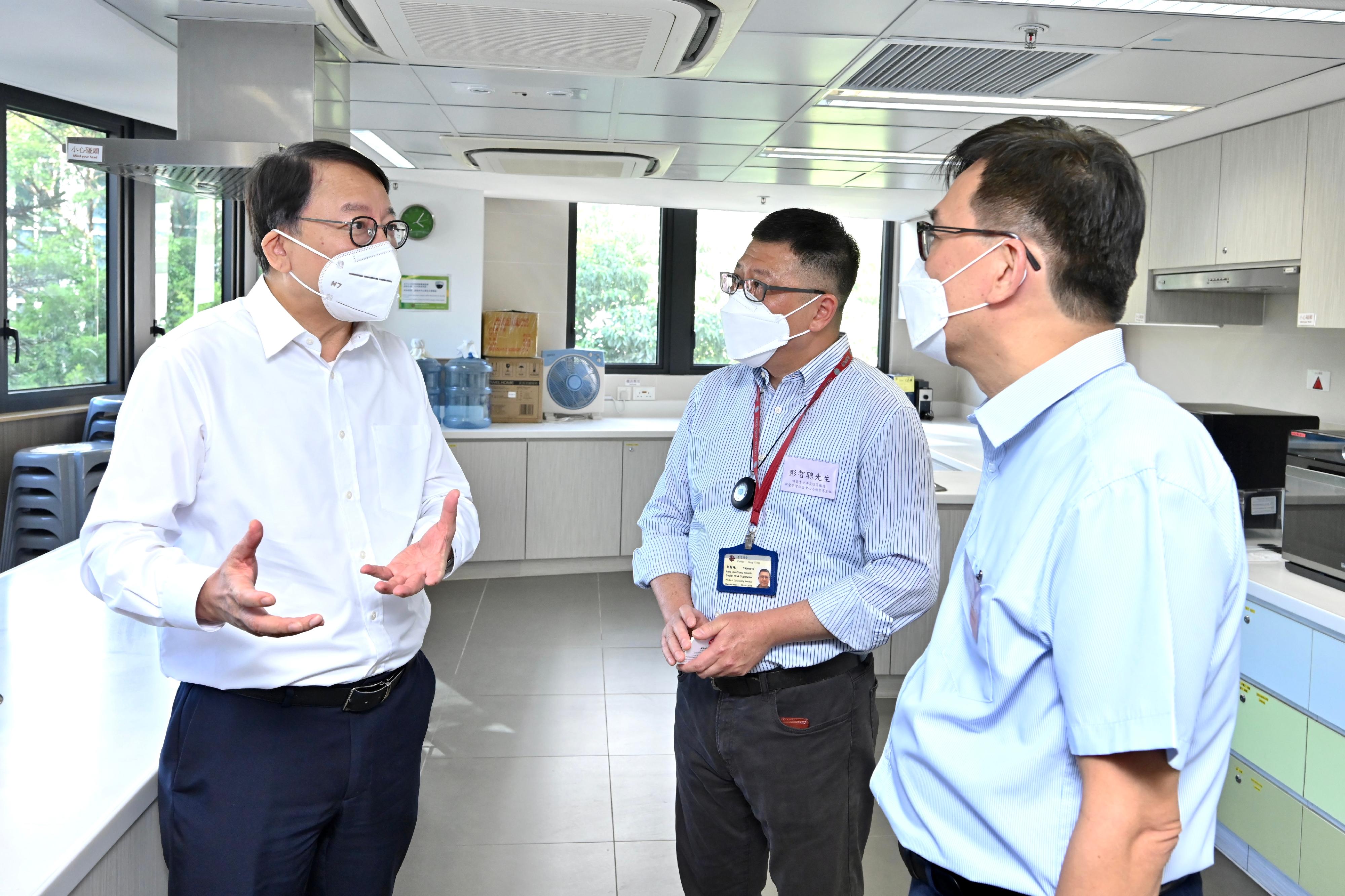 The Chief Secretary for Administration, Mr Chan Kwok-ki (first left), visited Caritas Community Centre - Tsuen Wan today (July 26) to learn from Caritas - Hong Kong representatives about the various facilities and services provided by the centre for grassroots families. They were in the kitchen of the centre.