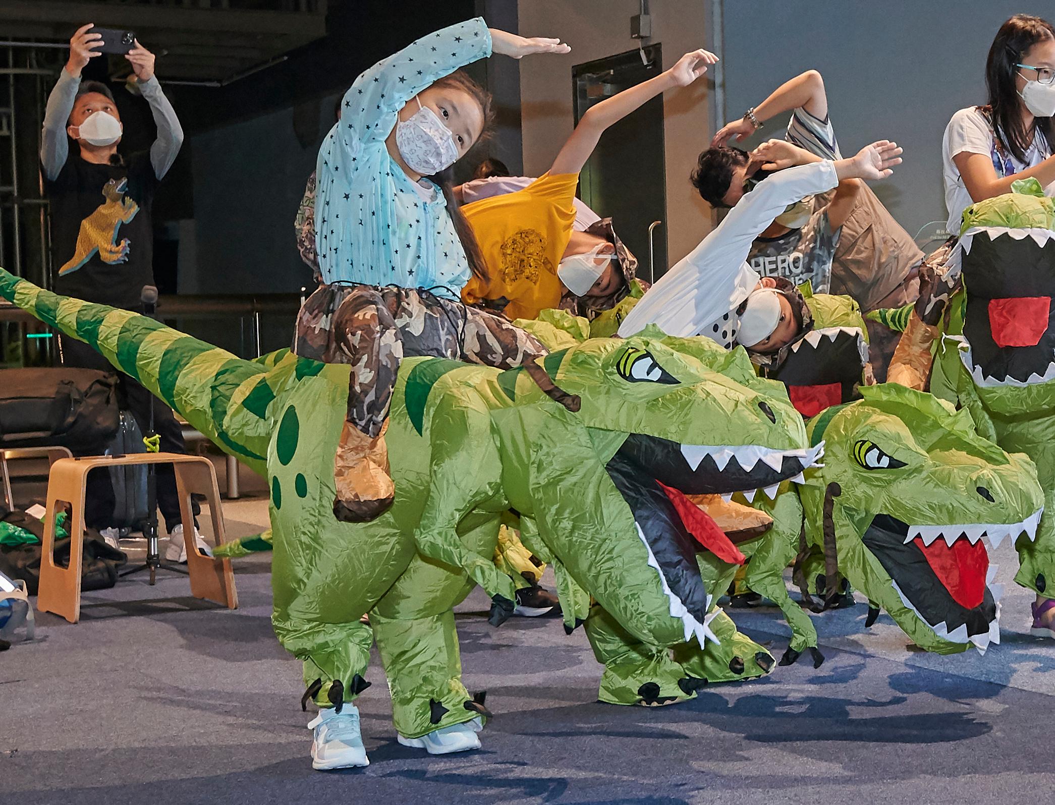 The first session of the Hong Kong Science Museum's "A Night with Dinosaurs" sleepover programme was completed today morning (August 6). Picture shows participants doing exercise in dinosaur costumes.