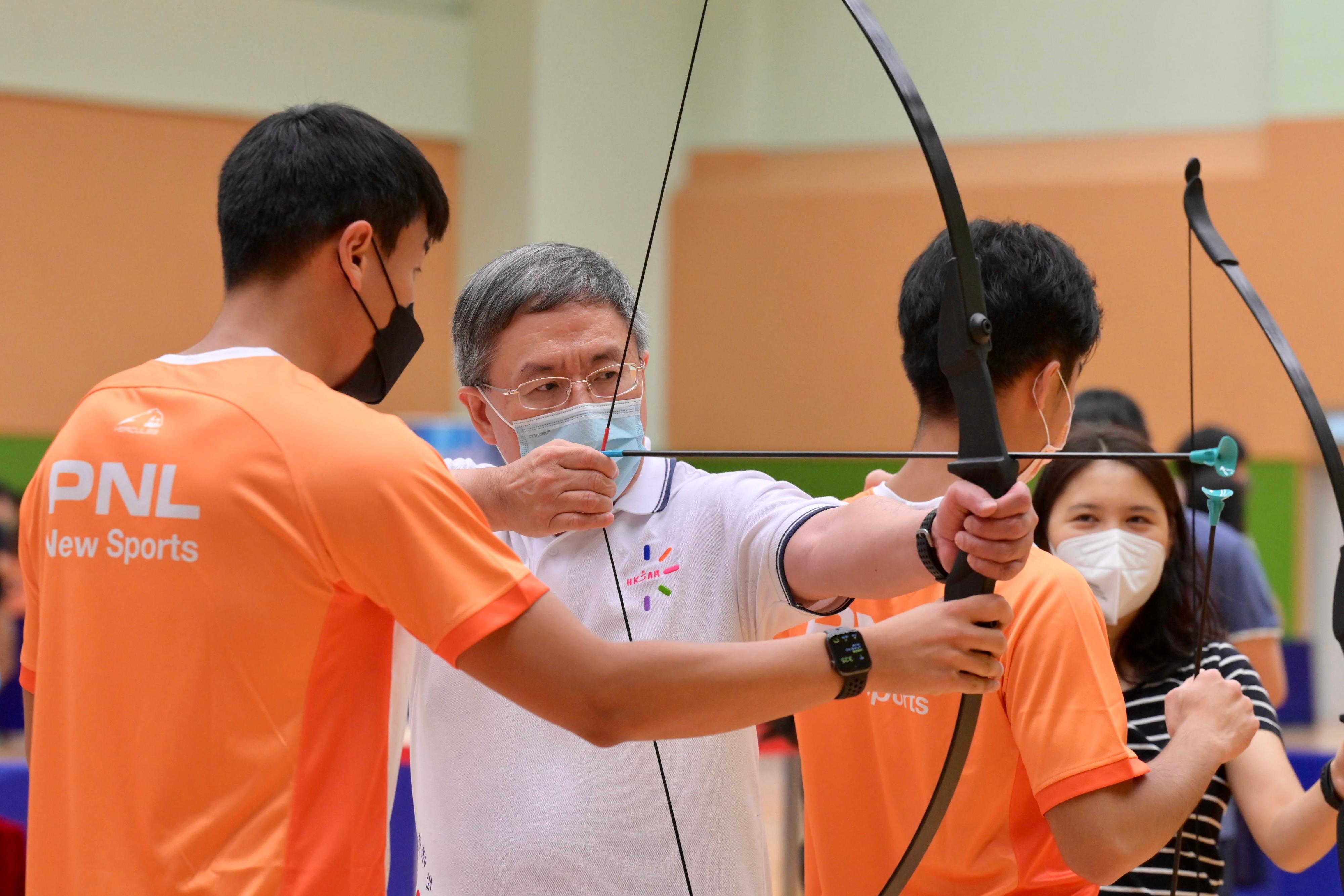 The Deputy Chief Secretary for Administration, Mr Cheuk Wing-hing (second left), joins the public for archery play-in activities at Island East Sports Centre today (August 7) as part of Sport for All Day 2022 to drive home the message of stay active, healthy and happy.