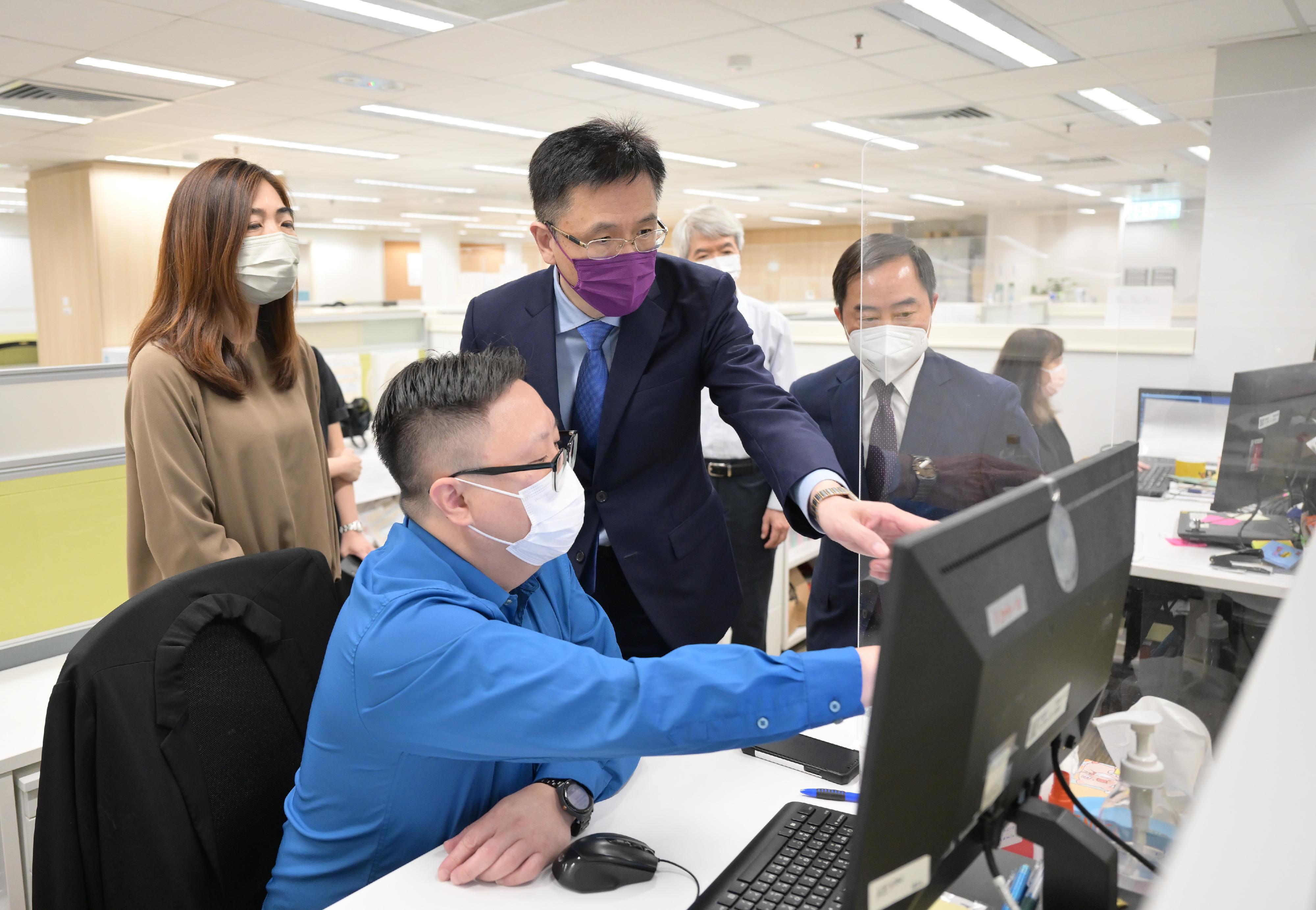 The Secretary for Innovation, Technology and Industry, Professor Sun Dong (second right), accompanied by the Deputy Government Chief Information Officer, Mr Tony Wong (first right), inspects the Compulsory Quarantine Support Centre set up by the Office of the Government Chief Information Officer in Wong Chuk Hang today (August 12) to learn about the operation of the centre.