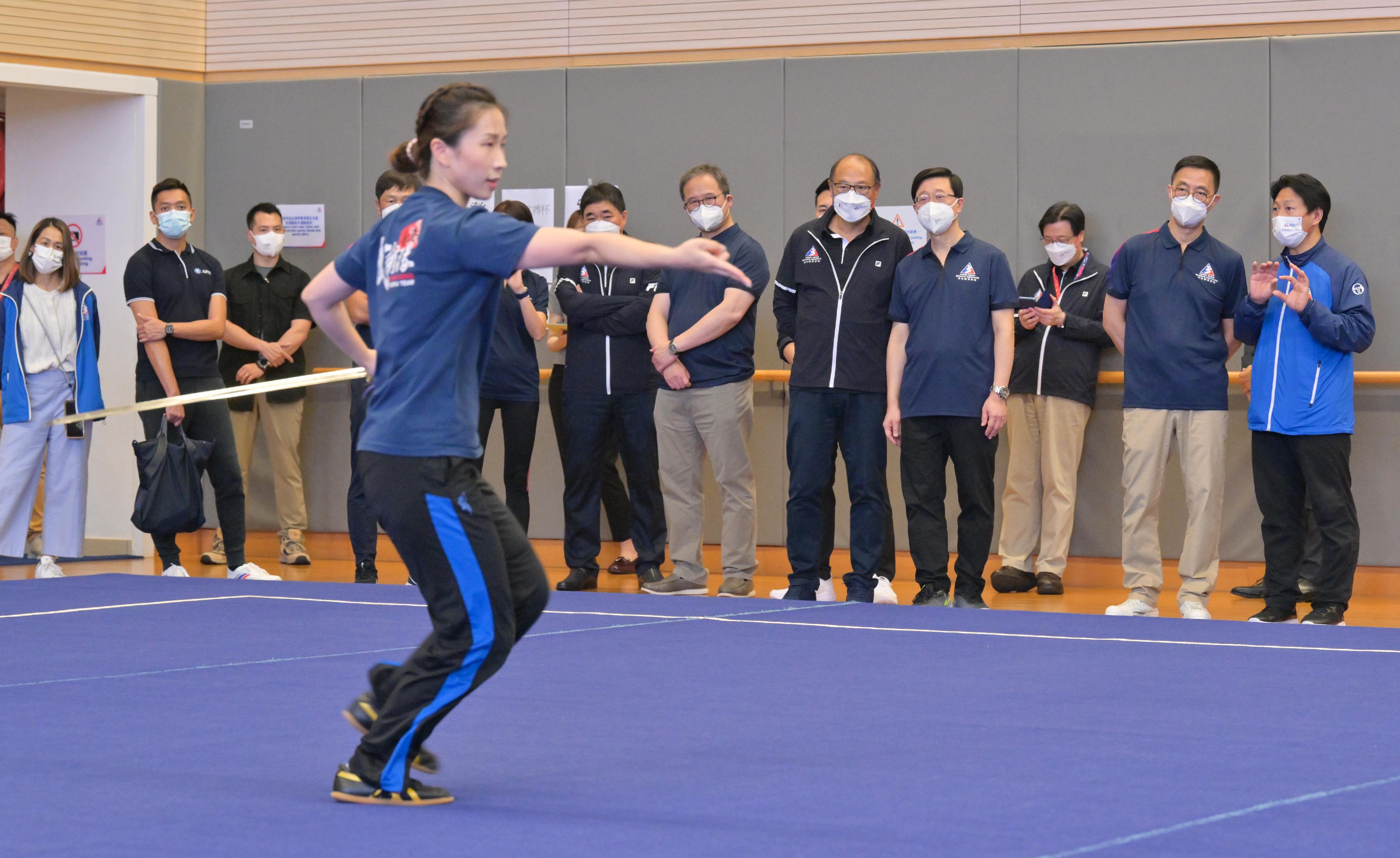 The Chief Executive, Mr John Lee, today (August 16) visited the Hong Kong Sports Institute (HKSI). Photo shows Mr Lee (back row, fourth right), watching a demonstration by a wushu athlete. Looking on are the Secretary for Culture, Sports and Tourism, Mr Kevin Yeung (back row, second right), and the Chairman of the Board of Directors of the HKSI, Dr Lam Tai-fai (back row, fifth right).