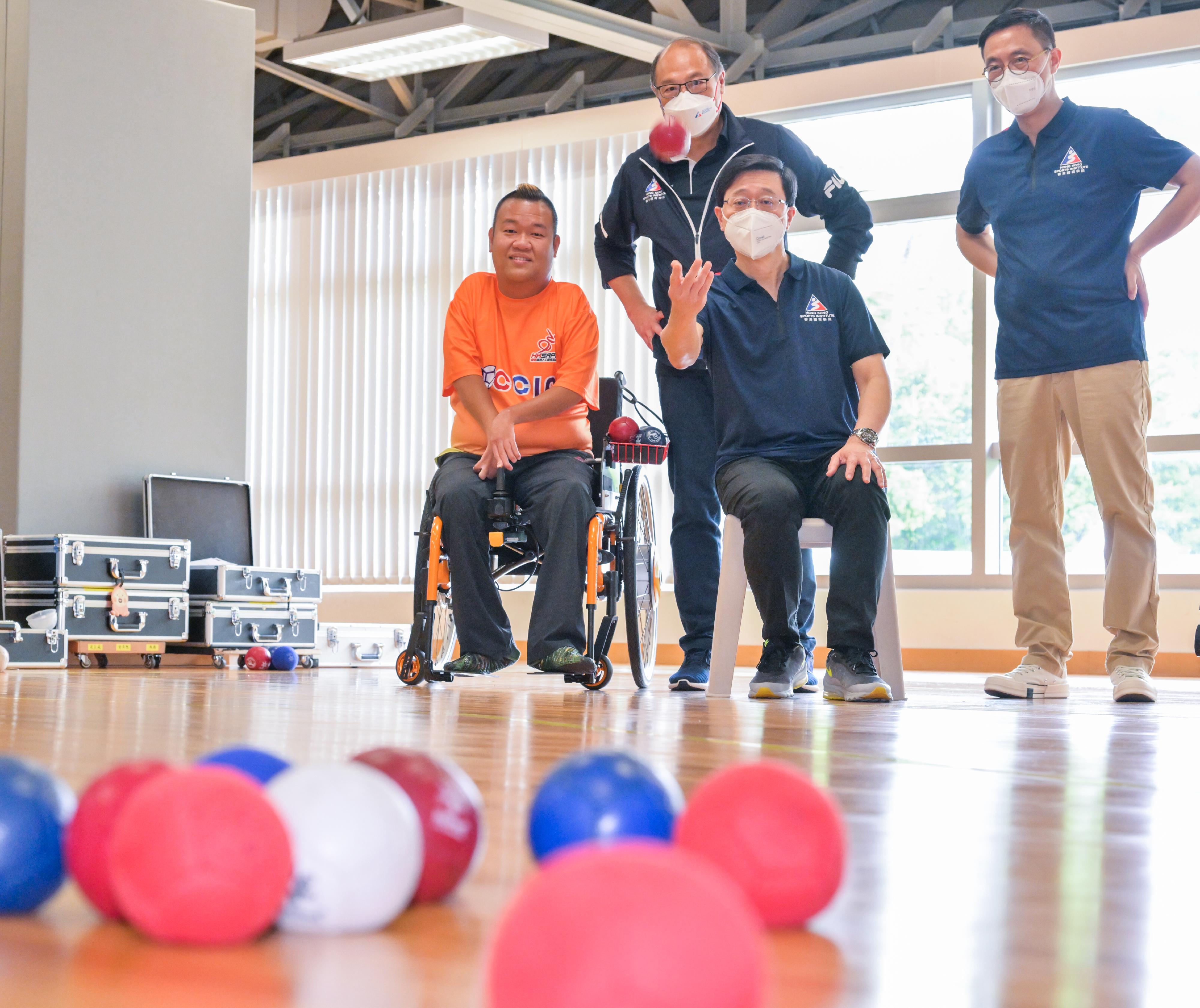 The Chief Executive, Mr John Lee, today (August 16) visited the Hong Kong Sports Institute (HKSI). Photo shows Mr Lee (front row, right), taking part in a boccia activity. Looking on are the Secretary for Culture, Sports and Tourism, Mr Kevin Yeung (back row, right), and the Chairman of the Board of Directors of the HKSI, Dr Lam Tai-fai (back row, left).