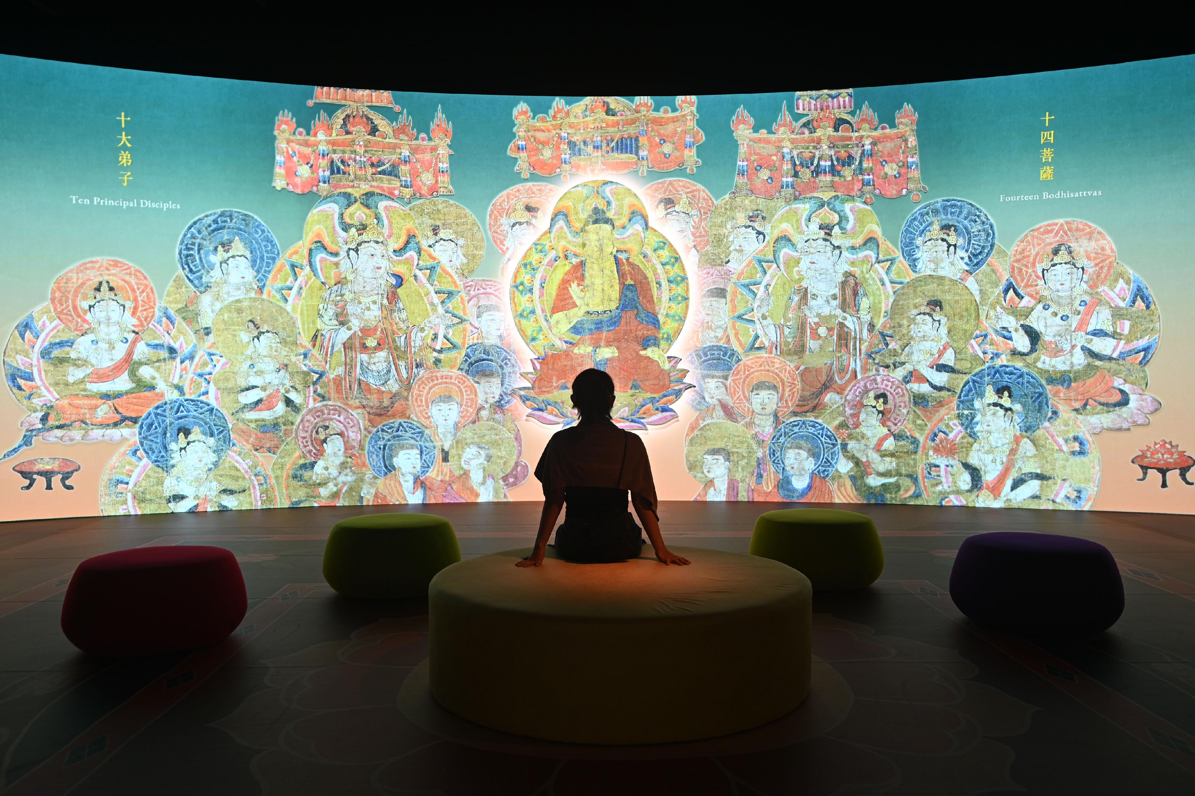 The opening ceremony for the exhibition "The Hong Kong Jockey Club Series: Dunhuang: Enchanting Tales for Millennium" was held today (August 23) at the Hong Kong Heritage Museum. Picture shows an immersive digital programme featuring the illustration of the "Sutra of the Profundity of Filial Love" silk  painting of the Northern Song dynasty, allowing visitors to appreciate the parental bonding conveyed by a series of heart-warming stories on the painting.
