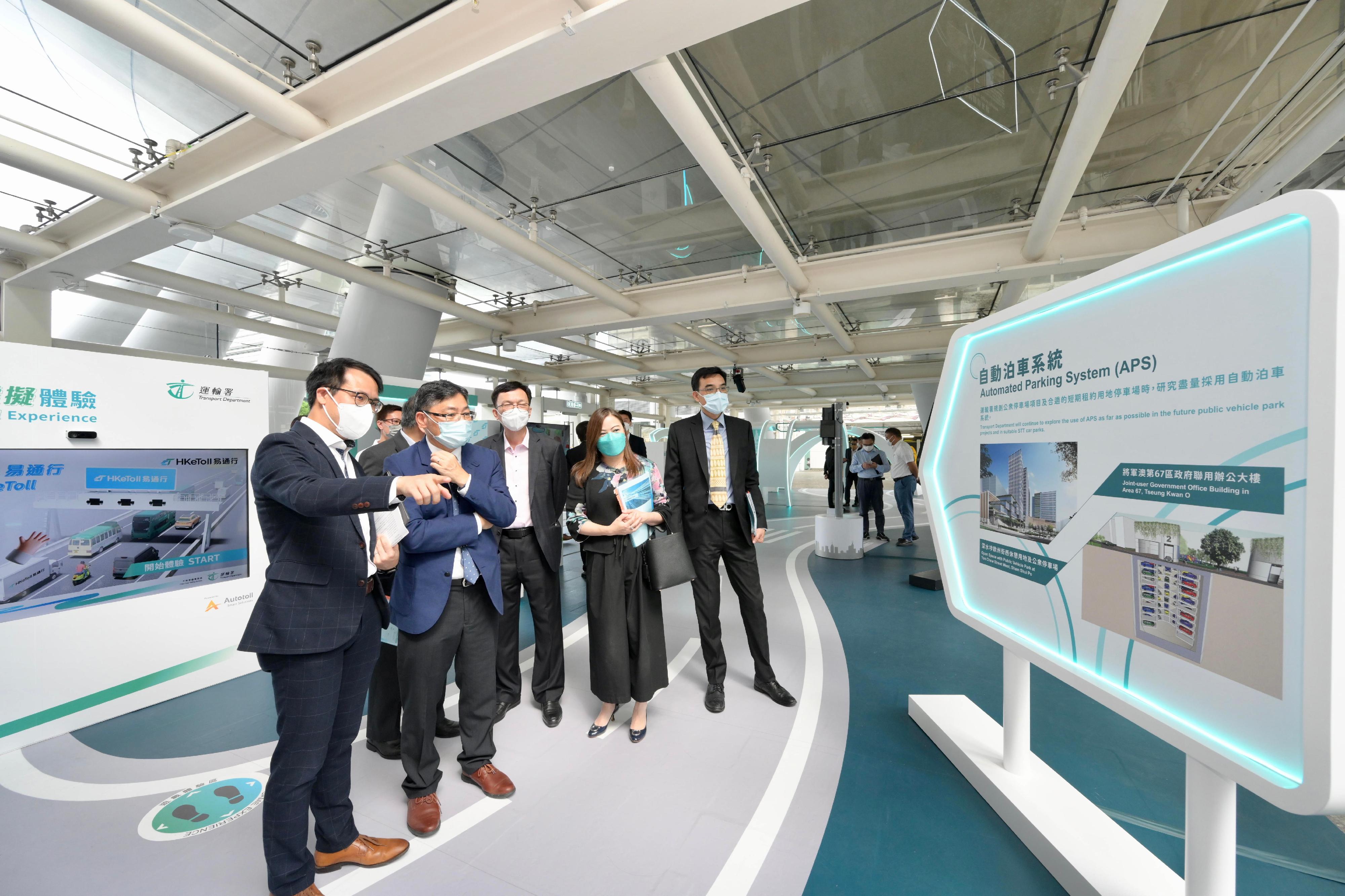 The Secretary for Transport and Logistics, Mr Lam Sai-hung, toured the "Journey Smart" roving exhibition held by the Transport Department (TD) at the Hong Kong Science Park. Photo shows Mr Lam (second left) being briefed by a TD representative on automated parking system. Also present are the Under Secretary for Transport and Logistics, Mr Liu Chun-san (third left), and the Commissioner for Transport, Miss Rosanna Law (second right).
