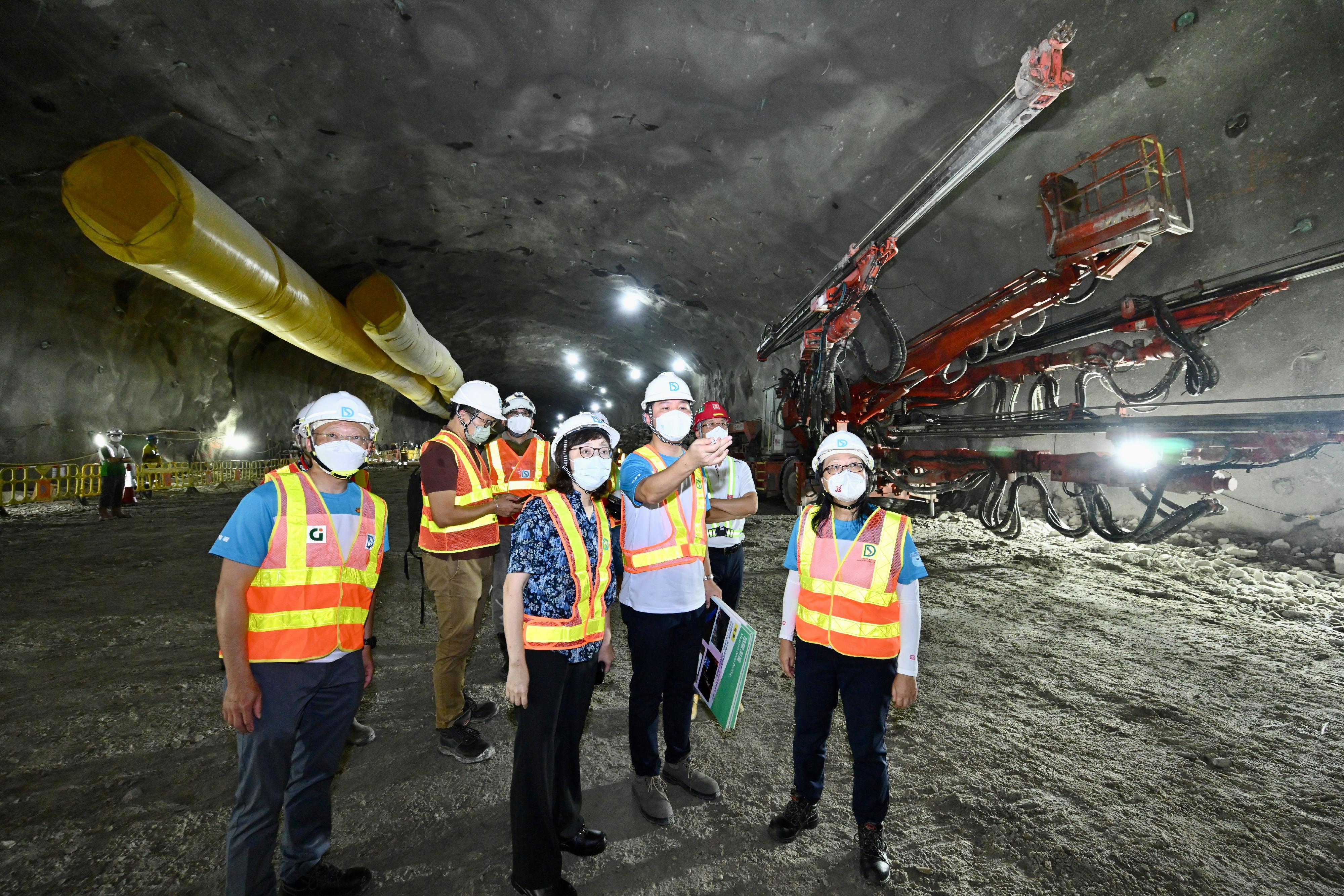 The Secretary for Development, Ms Bernadette Linn (third right), accompanied by the Director of Drainage Services, Ms Alice Pang (first right), attended the Relocation of Sha Tin Sewage Treatment Works to Caverns - Community Liaison Centre Open Day today (August 27). Photo shows them visiting the works site in the cavern to learn about the progress and challenges of the works.