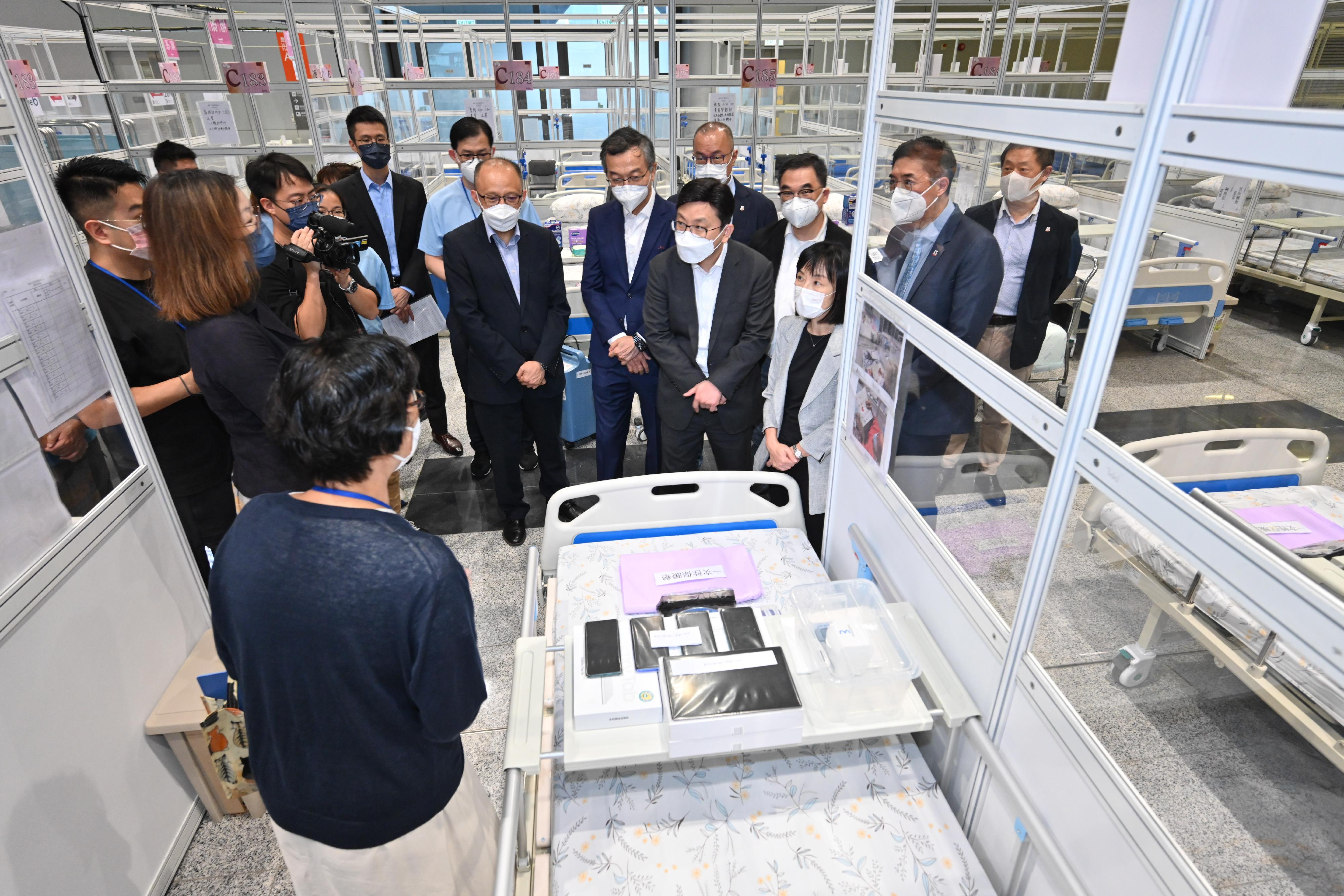 The Secretary for Labour and Welfare, Mr Chris Sun, today (September 1) visited the Kai Tak Quarantine Centre at the Kai Tak Cruise Terminal to learn more about the preparatory work prior to its commencement of operation tomorrow (September 2). Photo shows Mr Sun (front row, second right) and the Director of Social Welfare, Miss Charmaine Lee (front row, first right), learning from the care team about the equipment for the elderly during quarantine. 