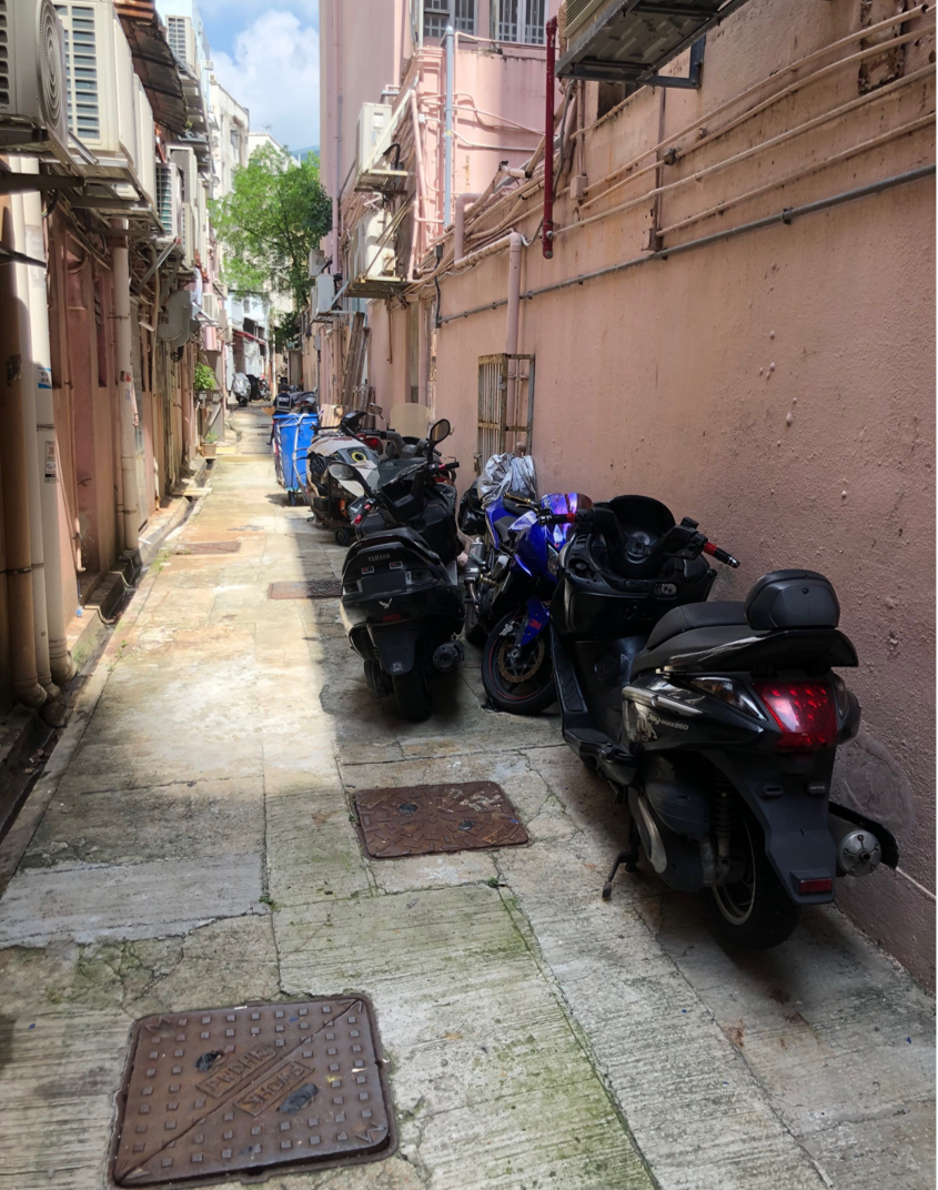The Home Affairs Department and its District Offices conducted a series of cleaning works, publicity and educational activities during July and August to support the Government Programme on Tackling Hygiene Black Spots launched under the District Matters Co-ordination Task Force. Photo shows a back alley in Kwun Tong before the joint operation for removal of abandoned vehicles co-ordinated by the Kwun Tong District Office and relevant departments.