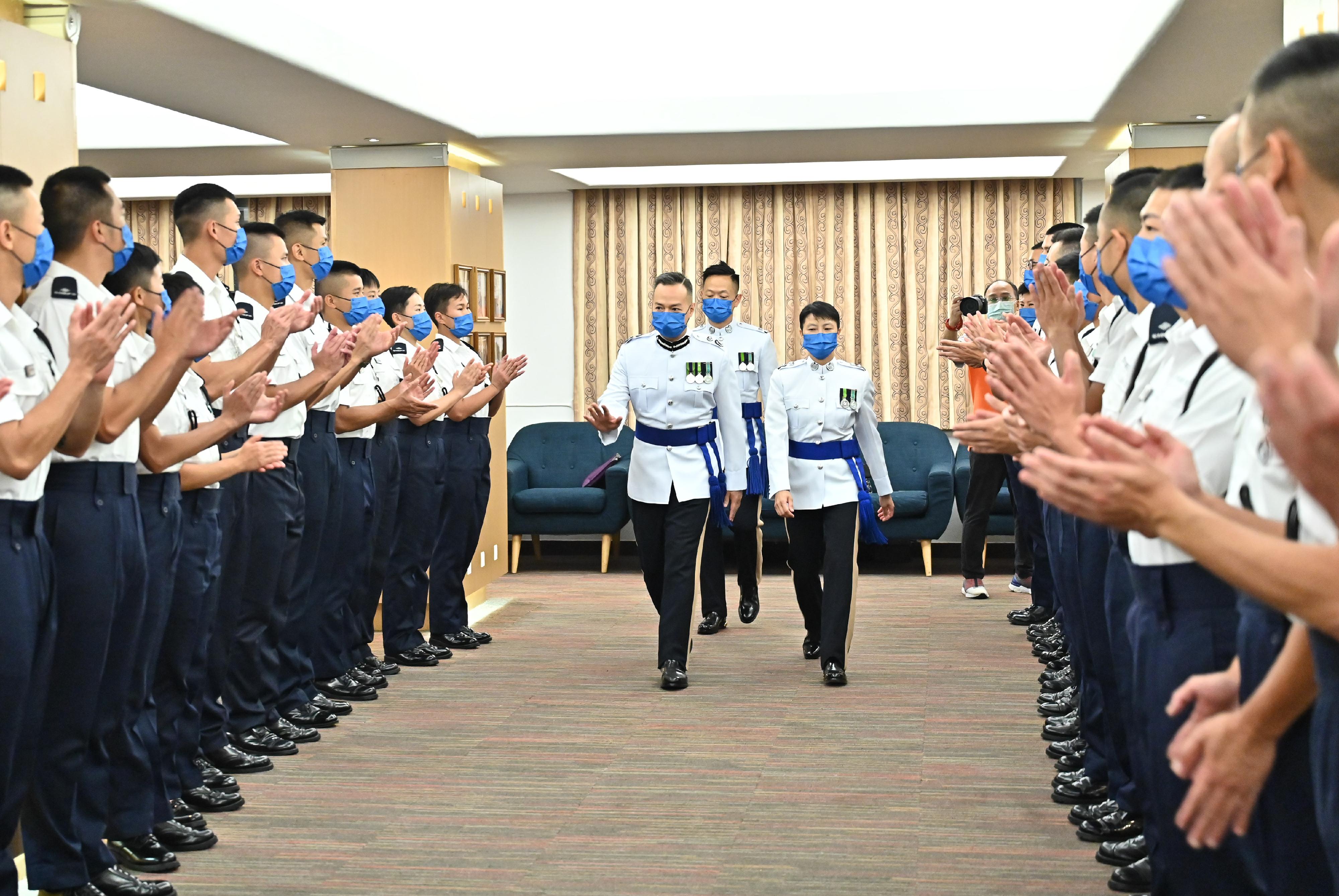 The Deputy Commissioner of Police (Management), Mr Chow Yat-ming, congratulates probationary inspectors after the passing-out parade held at the Hong Kong Police College today (September 17).