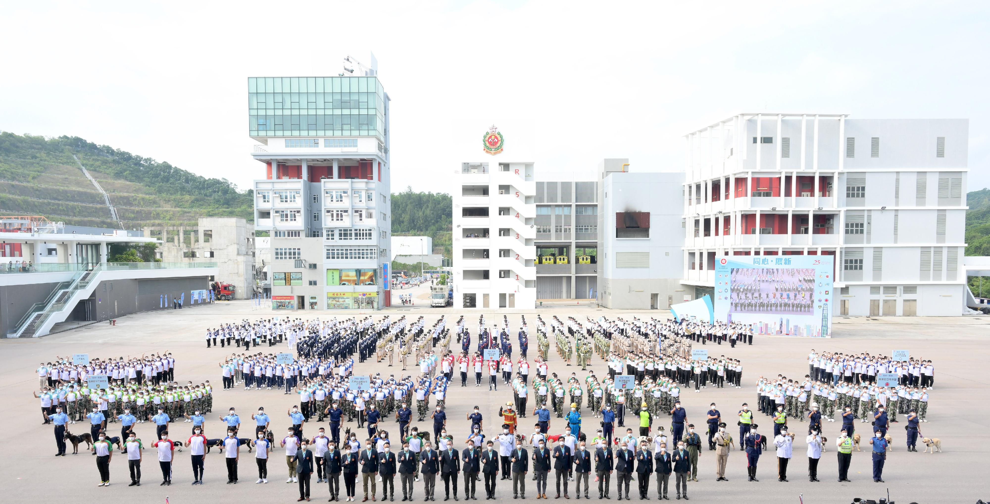 The Chief Executive, Mr John Lee, attended the "Together We Prosper" Grand Parade by Disciplined Services and Youth Groups for Celebrating the 73rd Anniversary of the Founding of the People's Republic of China and the 25th Anniversary of the Establishment of the Hong Kong Special Administrative Regiontoday (September 24). Photo shows (front row, from left) the Commissioner of the Civil Aid Service, Mr Lo Yan-lai;the Director of Fire Services, Mr Andy Yeung; the Commissioner of Customs and Excise, Ms Louise Ho;the Commissioner of Police, Mr Siu Chak-yee; the Permanent Secretary for Security, Mr Patrick Li; the Deputy Secretary for Justice, Mr Cheung Kwok-kwan; the Deputy Chief Secretary for Administration, Mr Cheuk Wing-hing; the Secretary for Justice, Mr Paul Lam, SC; the Chief Secretary for Administration, Mr Chan Kwok-ki; Mr Lee; the Financial Secretary, Mr Paul Chan; the Secretary for Security, Mr Tang Ping-keung; the Deputy Financial Secretary, Mr Michael Wong; the Secretary for Constitutional and Mainland Affairs, Mr Erick Tsang Kwok-wai; the Under Secretary for Security, Mr Michael Cheuk Hau-yip; the Director of Immigration, Mr Au Ka-wang; the Commissioner of Correctional Services, Mr Wong Kwok-hing; the Controller of the Government Flying Service, Captain Wu Wai-hung; the Commissioner of the Auxiliary Medical Service, Dr Ronald Lam, and performers at the event.
