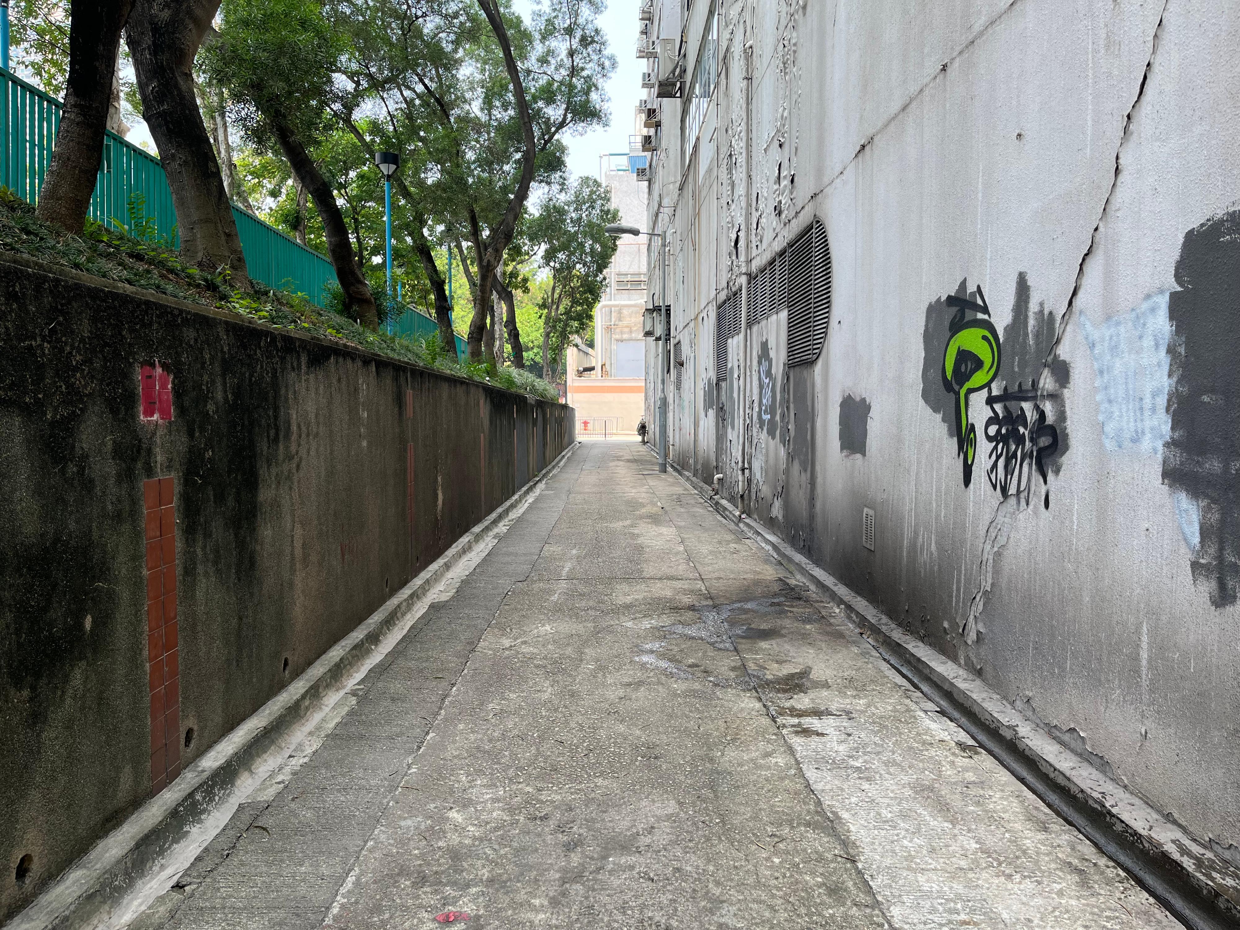 The Home Affairs Department and its District Offices conducted a series of cleaning works, publicity and educational activities during July and September to support the Government Programme on Tackling Hygiene Black Spots launched under the District Matters Co-ordination Task Force. Photo shows a back alley in Kowloon City after the joint operation for removal of abandoned vehicles co-ordinated by the Kowloon City District Office and relevant departments. 