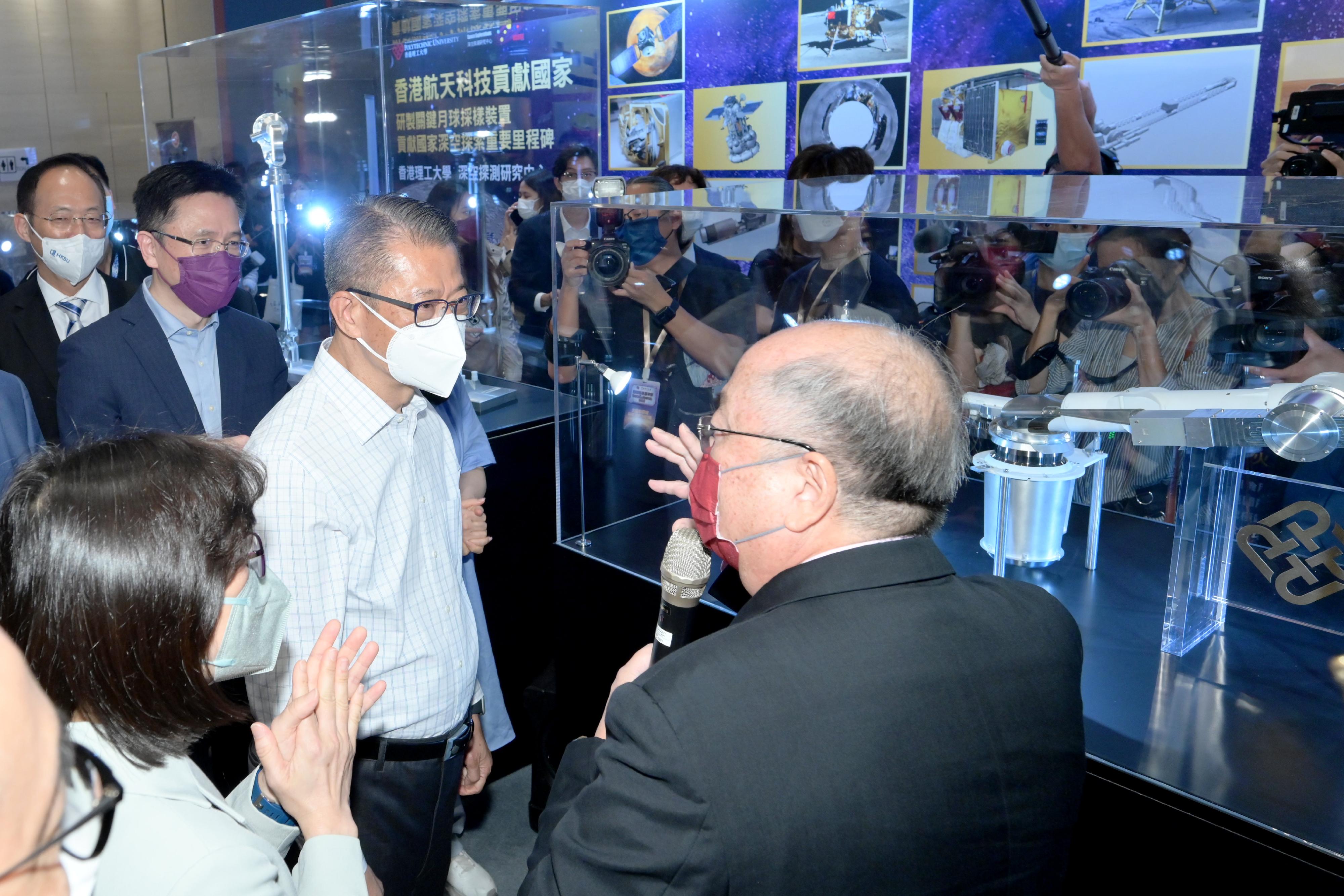 The Financial Secretary, Mr Paul Chan, attended the opening ceremony of InnoCarnival 2022 today (October 22). Photo shows Mr Chan (second right), and the Secretary for Innovation, Technology and Industry, Professor Sun Dong (third right), visiting the Aerospace Showcase, which features precision space instruments locally developed and fabricated by the Hong Kong Polytechnic University.