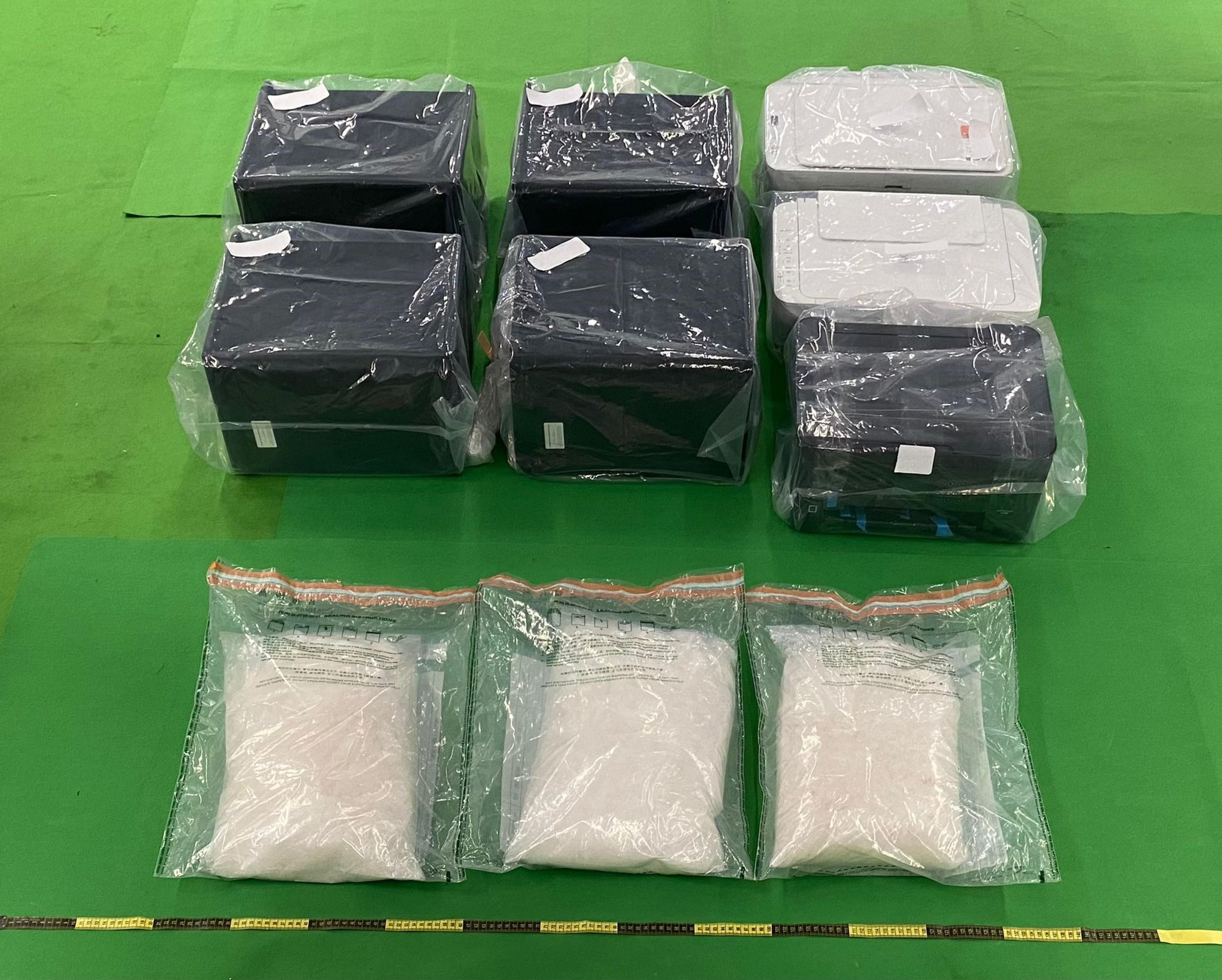 Hong Kong Customs detected five dangerous drugs cases, in which local freight consolidators were being exploited, at Hong Kong International Airport between end-July and mid-October this year and seized about 29 kilograms of suspected methamphetamine and about 12kg of suspected cannabis buds with a total estimated market value of about $20 million. Photo shows the suspected methamphetamine seized by Customs officers in the second and third cases as well as three printers and four speakers used to conceal the drugs.