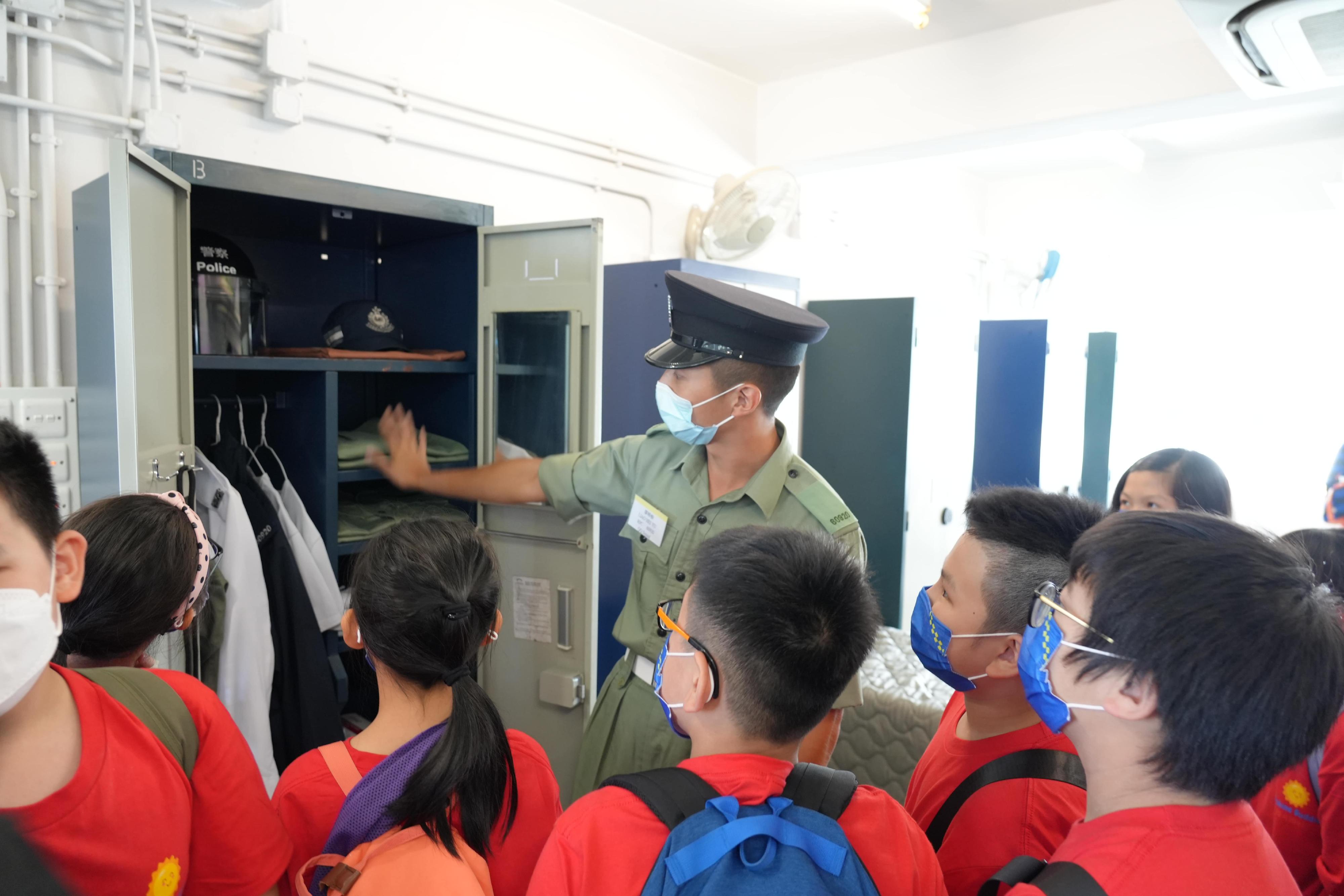 The Secretary for Security, Mr Tang Ping-keung, today (October 29) attended the inaugural event of the Security Bureau volunteer programme Sunshine Buddies at the Police College in Wong Chuk Hang. Photo shows participants visiting the Barrack Blocks at the Hong Kong Police College and interacting with recruit police constable.