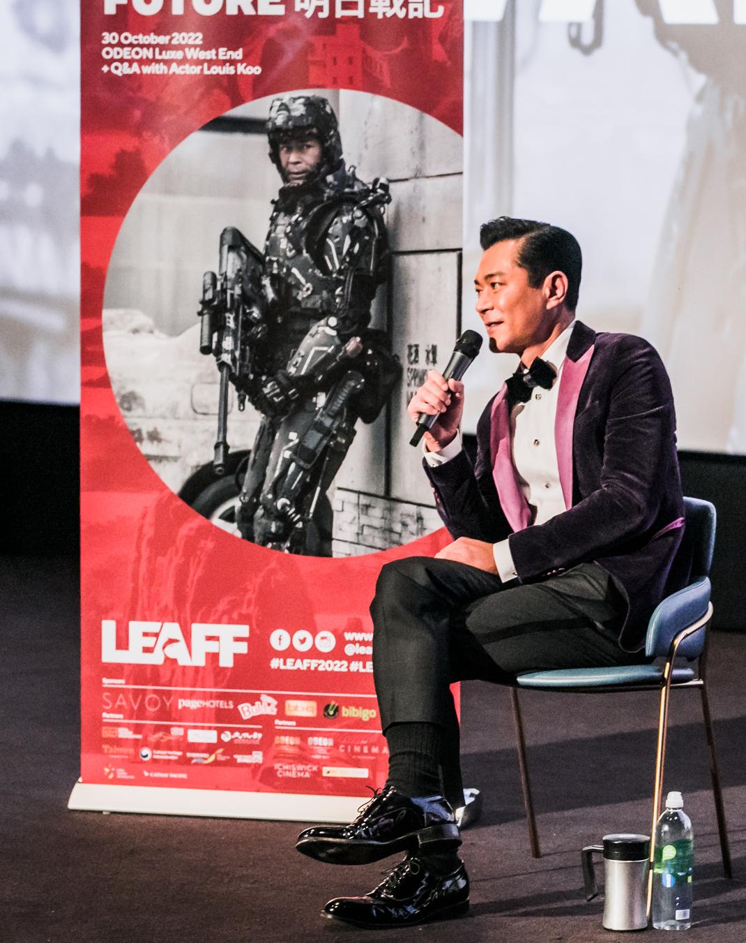 To commemorate the 25th anniversary of the establishment of the Hong Kong Special Administrative Region, the Hong Kong Economic and Trade Office, London supported the London East Asia Film Festival, showcasing seven Hong Kong films in London from October 19 to 30 (London time). Photo shows Hong Kong actor Louis Koo exchanging views with the audience at a question-and-answer session of the film festival.  