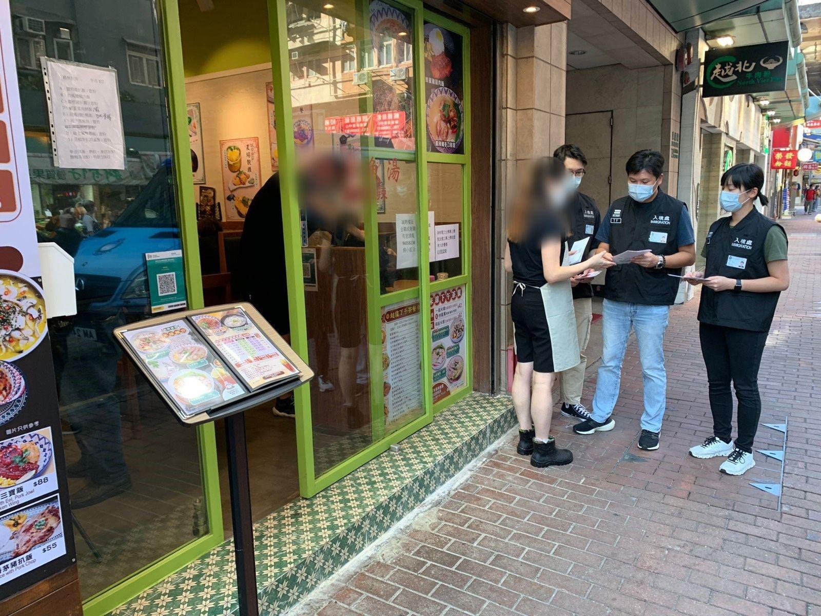 The Immigration Department mounted a series of    territory-wide anti-illegal worker operations codenamed "Breakthrough" and "Twilight" for four consecutive days from November 6 to today (November 9). Photo shows Immigration investigation sub-division officers distributing "Don't Employ Illegal Workers" leaflets to restaurant staff.