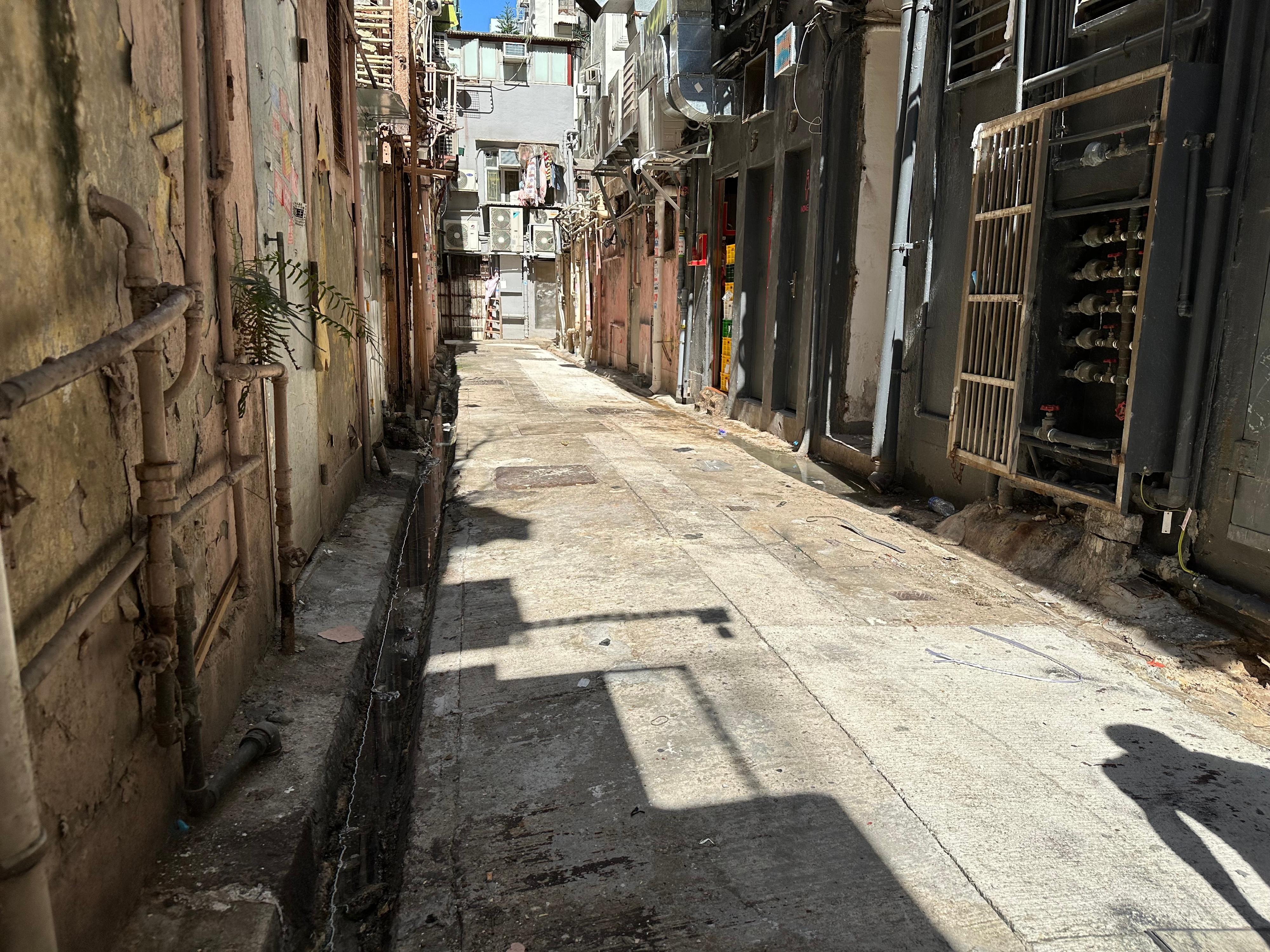 The Home Affairs Department and its District Offices conducted a series of cleaning works, publicity and educational activities during July and October to support the Government Programme on Tackling Hygiene Black Spots launched under the District Matters Co-ordination Task Force. Photo shows a back alley in Sham Shui Po after the joint operation for removal of abandoned vehicles co-ordinated by the Sham Shui Po District Office and relevant departments. 