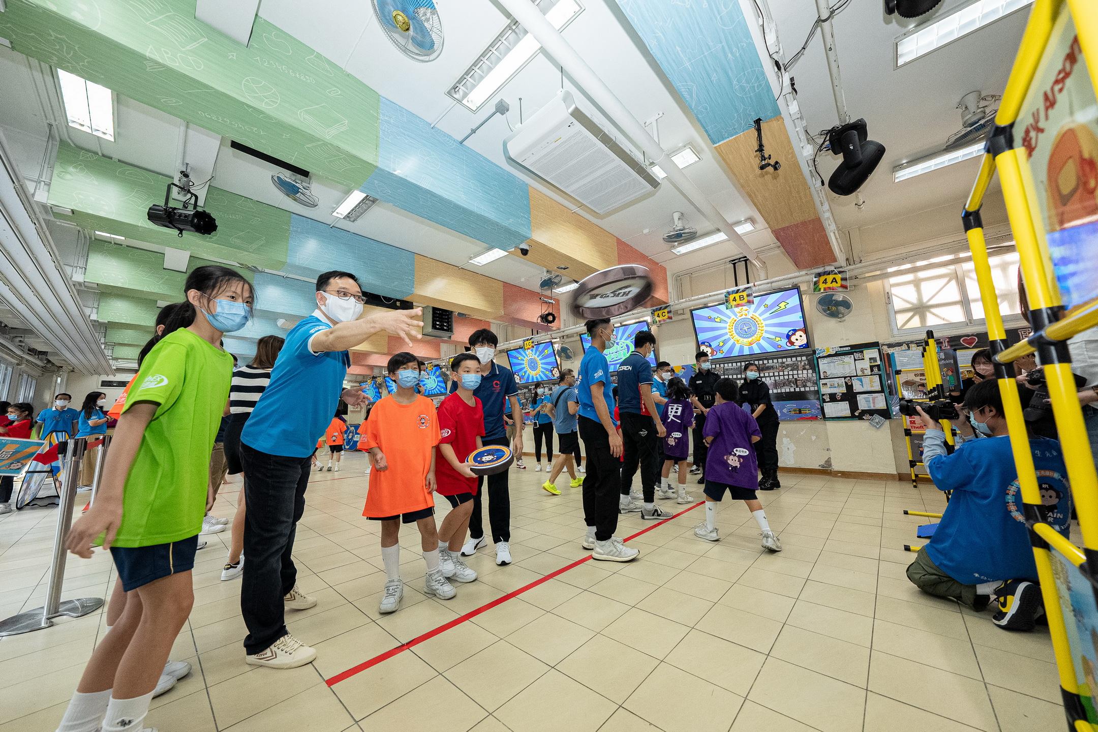 The Correctional Services Department held the kick-off ceremony of its brand-new community education activity "Rehabilitation Express" today (November 11). Photo shows the Commissioner of Correctional Services, Mr Wong Kwok-hing (second left), playing dodgebee with students.