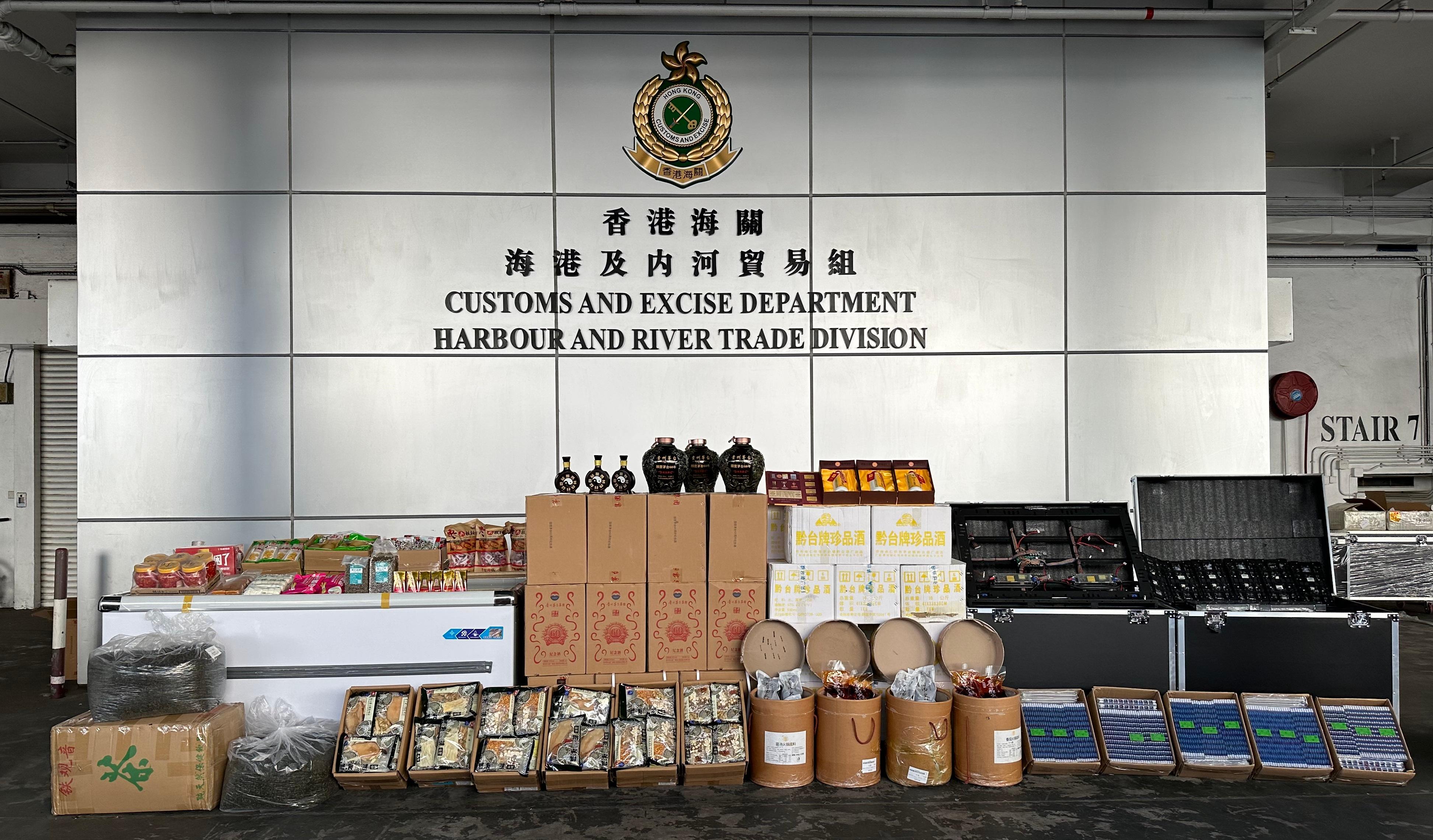 Hong Kong Customs on November 18 seized about 710 bottles of suspected smuggled liquor with a total volume of about 490 litres at the Tuen Mun River Trade Terminal Customs Cargo Examination Compound. The estimated market value and the duty potential were $4.6 million and $2.3 million approximately. In addition, Customs officers at the same time seized a batch of suspected smuggled goods with an estimated market value of about $160,000. Photo shows some of the suspected smuggled liquor and other suspected smuggled goods seized.