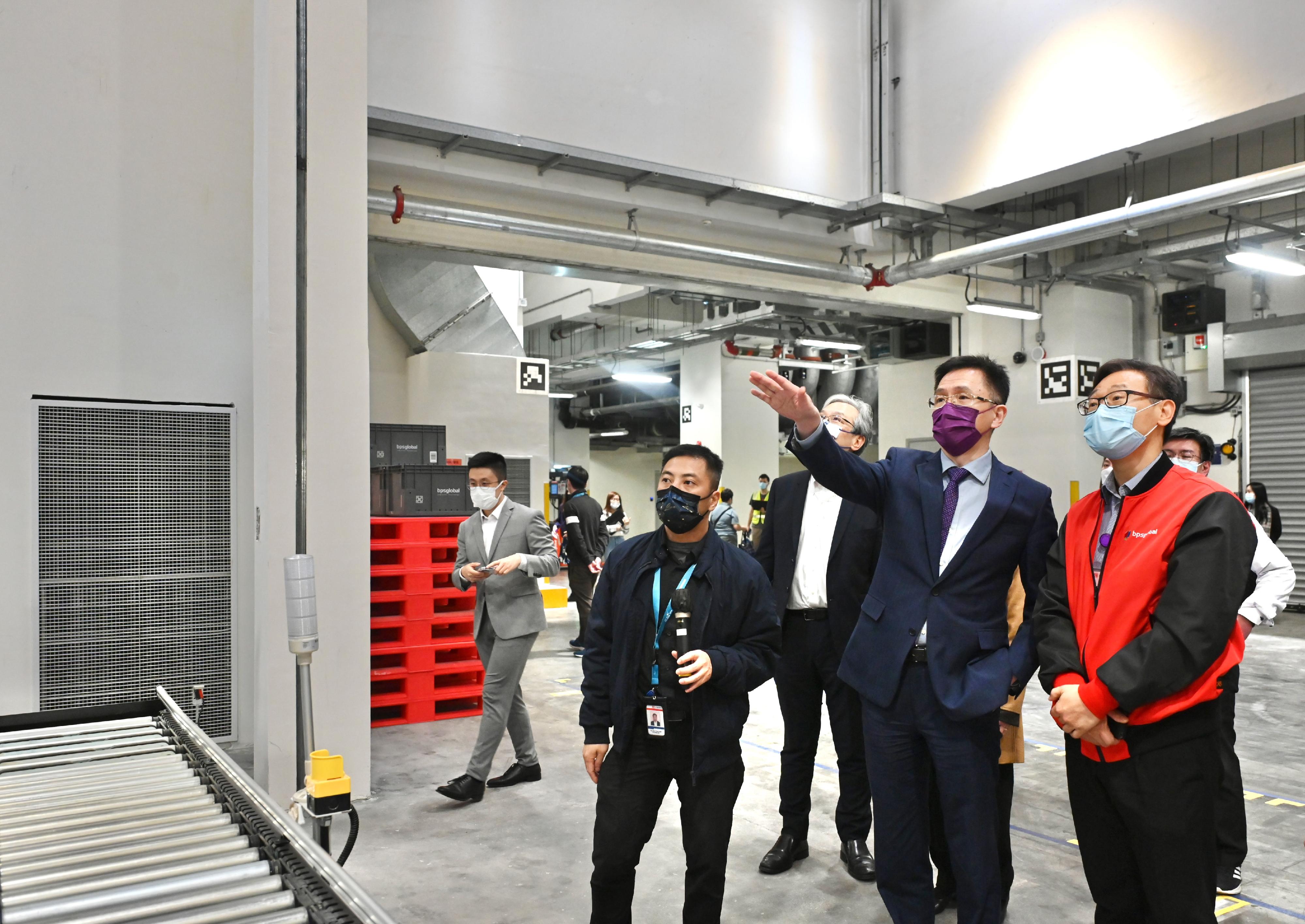 The Secretary for Innovation, Technology and Industry, Professor Sun Dong (second right), tours an enterprise that focuses on smart logistics and supply chain management in the Advanced Manufacturing Centre today (December 1).