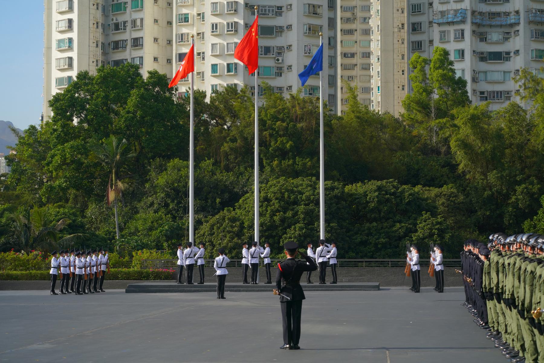 The Flag Party performs a Chinese-style flag-raising ceremony at the Immigration Department Passing-out Parade today (December 2).
