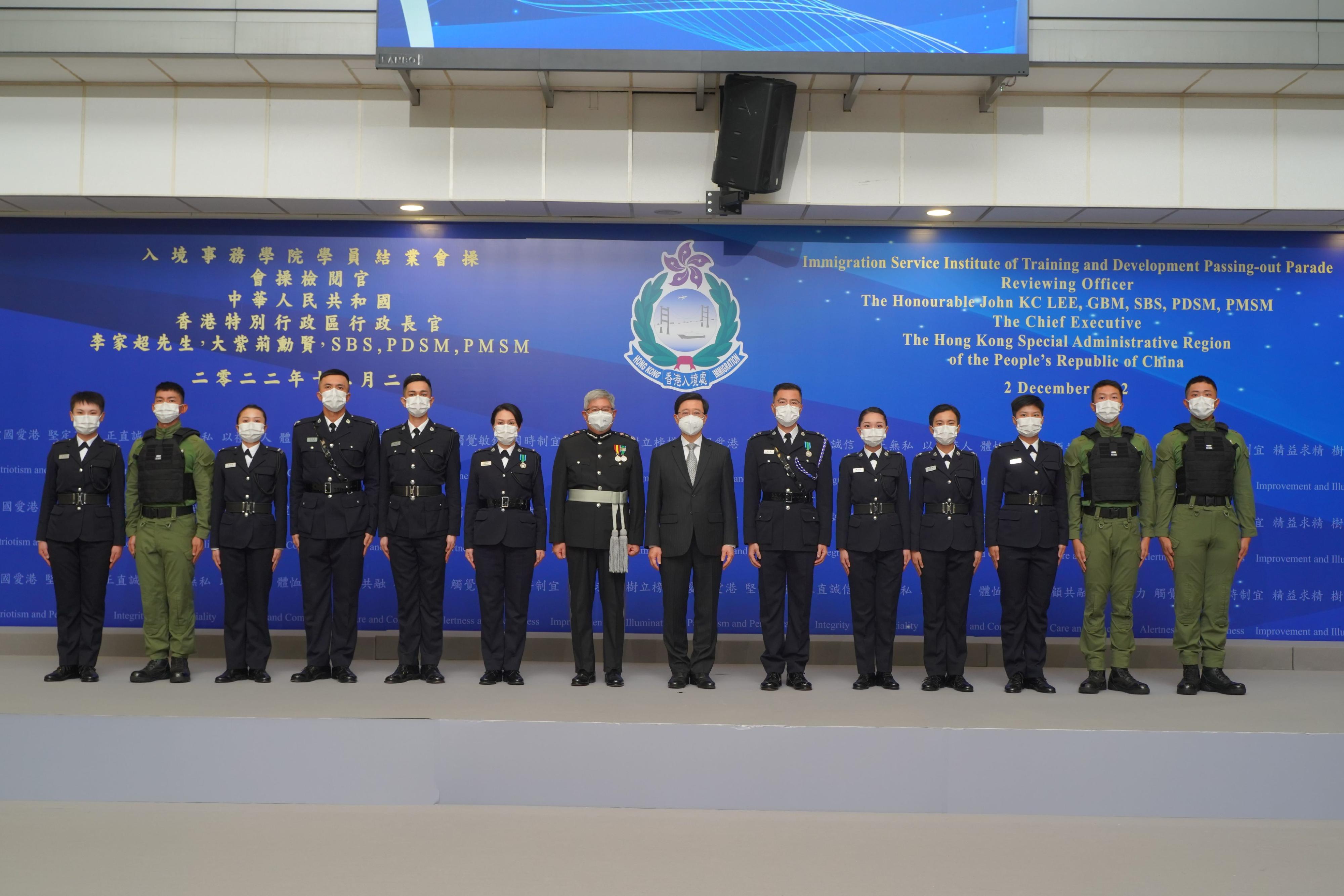 The Chief Executive, Mr John Lee (seventh right), is pictured with the Director of Immigration, Mr Au Ka-wang (seventh left), as well as graduates awarded the "Best Recruit Shields" and other guests, after the Immigration Department Passing-out Parade today (December 2).
