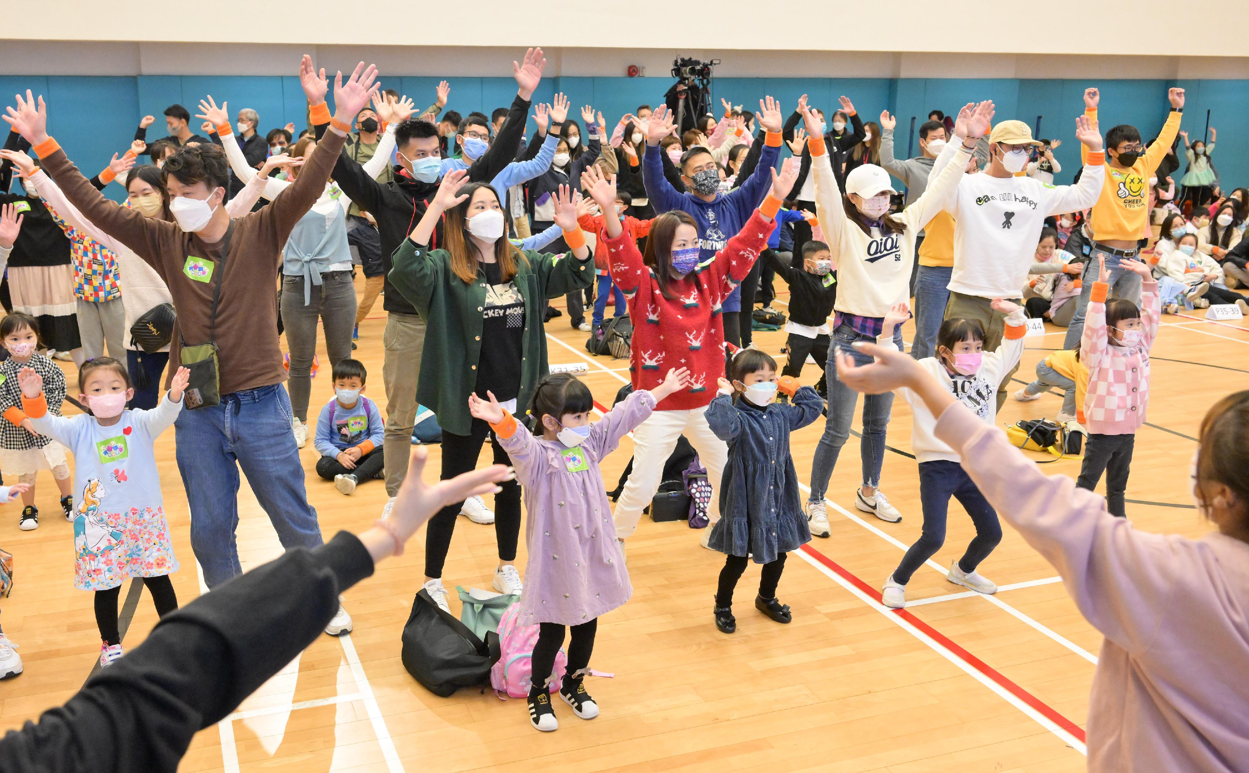 Parents and children learn dance steps with different levels of difficulty at the Play with Your Children Day today (December 11).