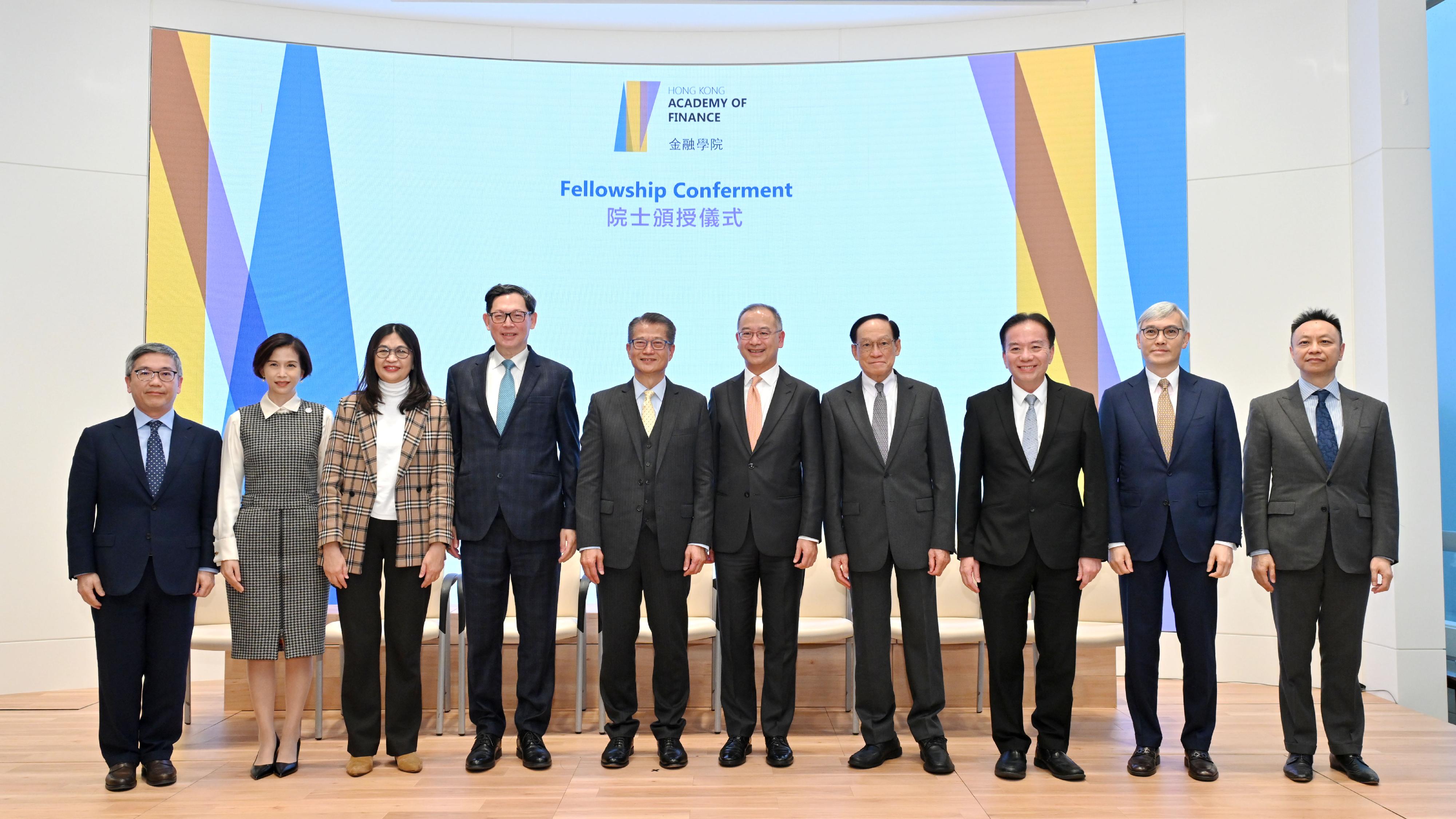 The Financial Secretary, Mr Paul Chan, attended the Hong Kong Academy of Finance (AoF) Fellowship Conferment and Financial Leaders Programme Graduation Ceremony this afternoon (December 14). Photo shows Mr Chan (fifth left); the Chairman of the AoF and the Chief Executive of the Hong Kong Monetary Authority, Mr Eddie Yue (fifth right); Fellow of the AoF, Dr Norman Chan (fourth left); Fellow of the AoF, Professor Edward Chan (fourth right);  Fellow of the AoF, Dr David Wong (third right), and members of the Board of Directors of the AoF.