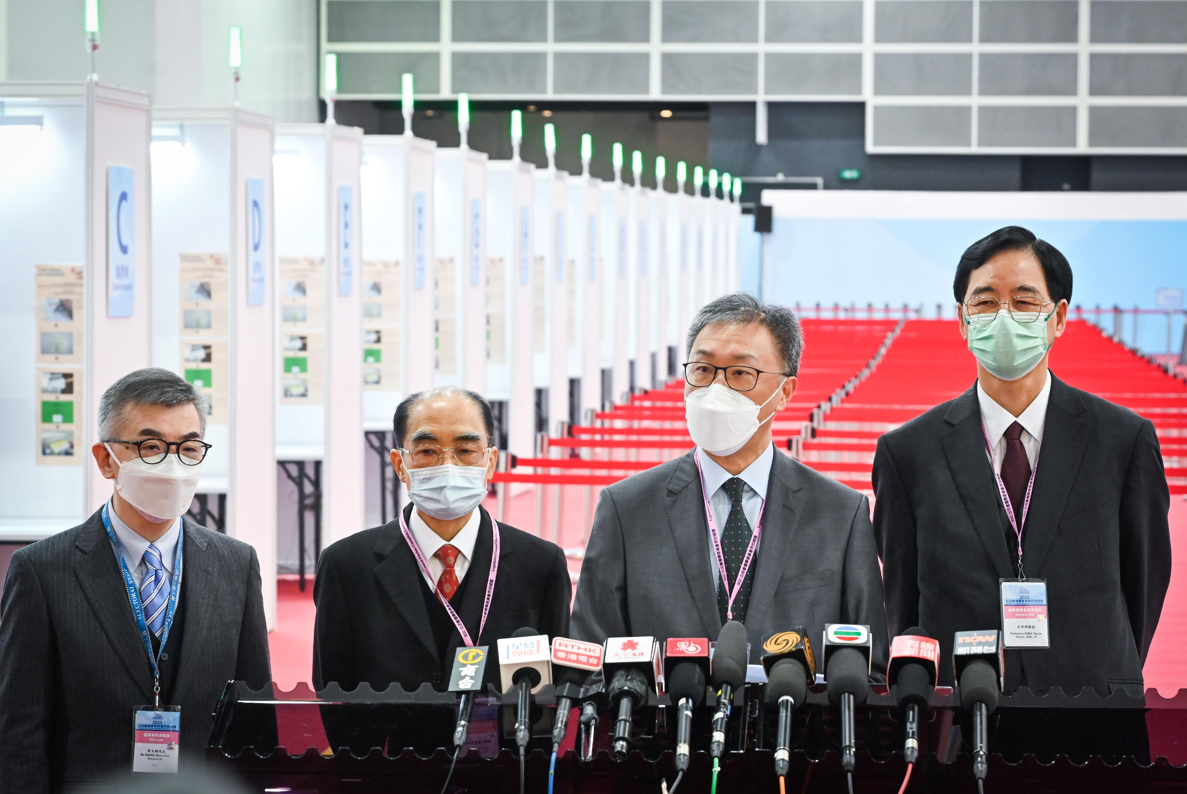 The Chairman of the Electoral Affairs Commission (EAC), Mr Justice David Lok (second right); EAC members Mr Arthur Luk, SC (second left), and Professor Daniel Shek (first right) met the media after visiting the polling station and central counting station of the 2022 Legislative Council Election Committee constituency by-election at the Hong Kong Convention and Exhibition Centre today (December 17). Also present was the Chief Electoral Officer of the Registration and Electoral Office, Mr Raymond Wang (first left).