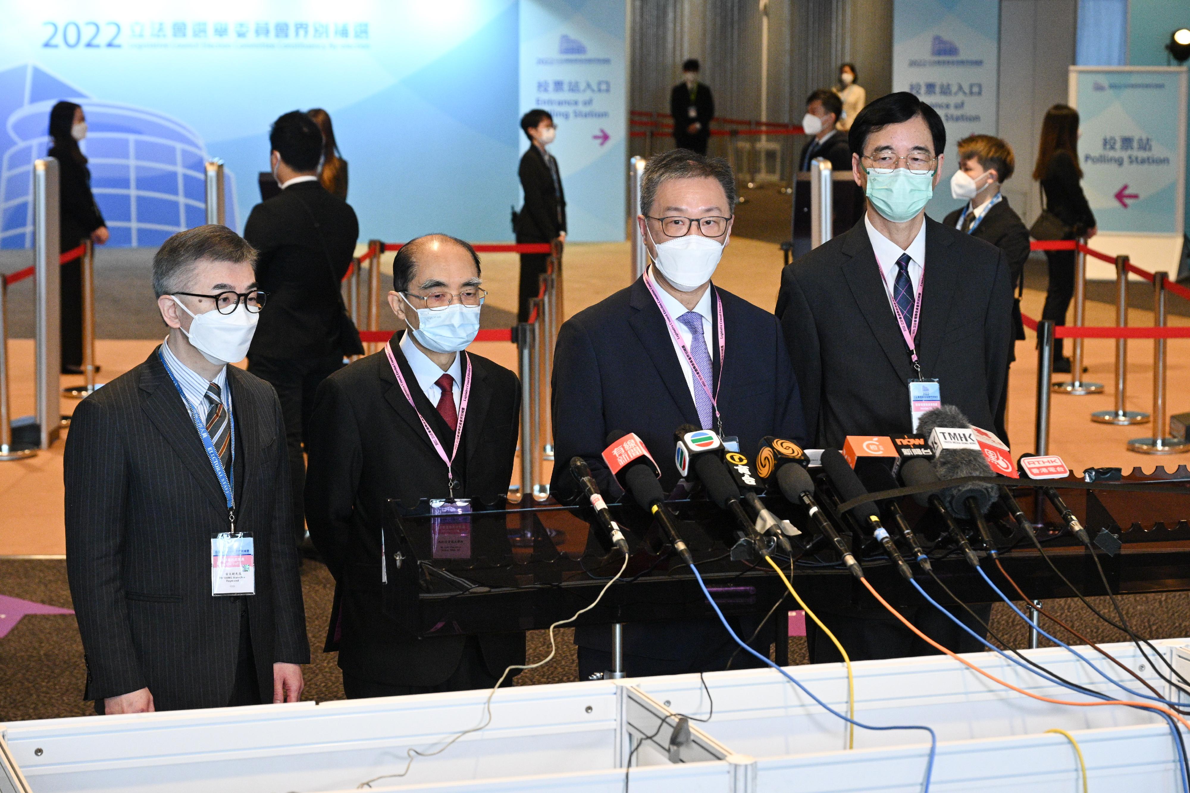 The Chairman of the Electoral Affairs Commission (EAC), Mr Justice David Lok (second right), EAC members Mr Arthur Luk, SC (second left), and Professor Daniel Shek (first right) met the media after their visit to the central counting station and polling station of the 2022 Legislative Council Election Committee constituency by-election at the Hong Kong Convention and Exhibition Centre this morning (December 18). Also present was the Chief Electoral Officer of the Registration and Electoral Office, Mr Raymond Wang (first left).