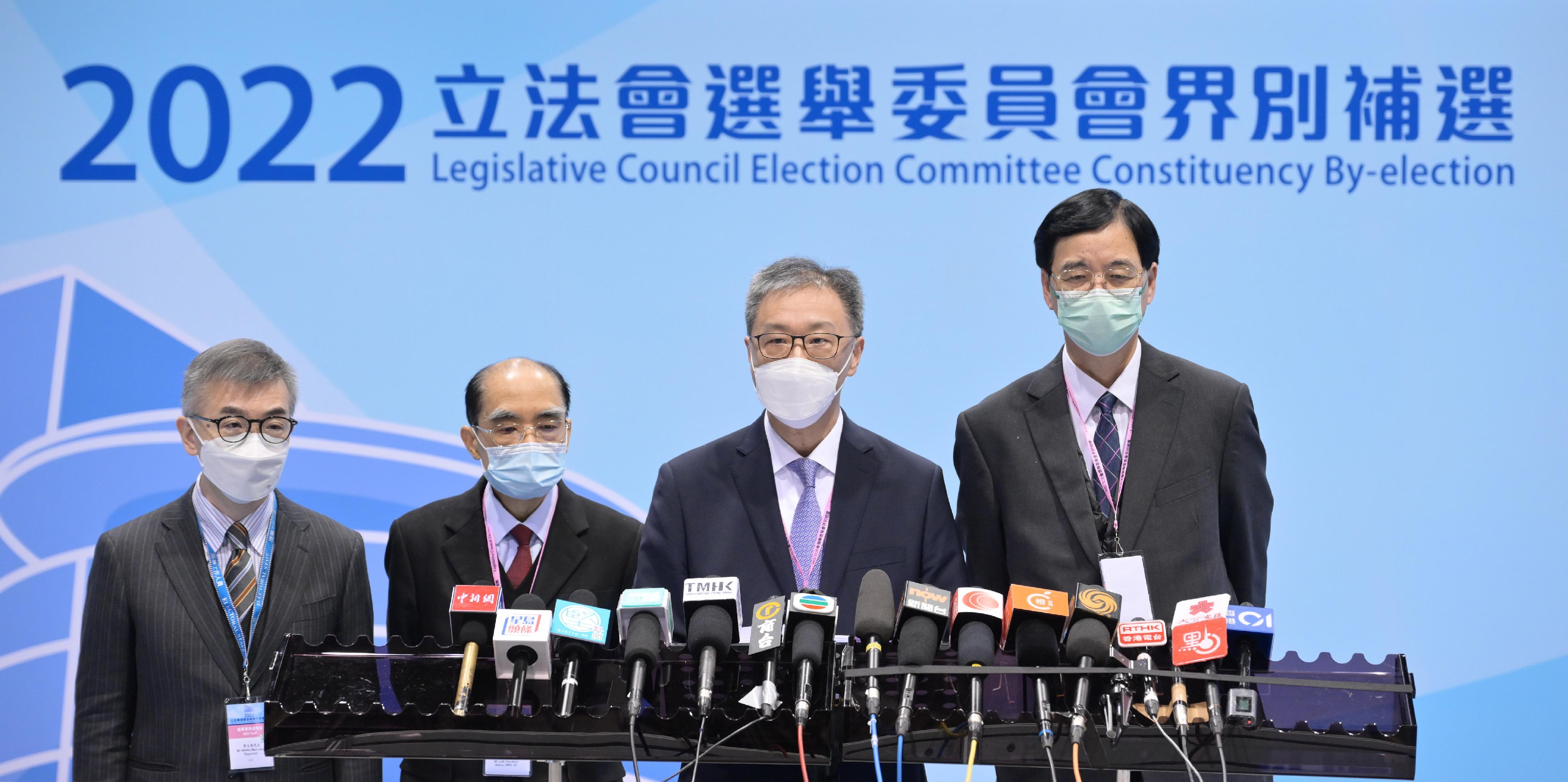 The Chairman of the Electoral Affairs Commission (EAC), Mr Justice David Lok (second right); EAC members Mr Arthur Luk, SC (second left), and Professor Daniel Shek (first right); and the Chief Electoral Officer of the Registration and Electoral Office, Mr Raymond Wang (first left), met the media to conclude the by-election today (December 18) at the media centre of the central counting station of the 2022 Legislative Council Election Committee constituency by-election at the Hong Kong Convention and Exhibition Centre.