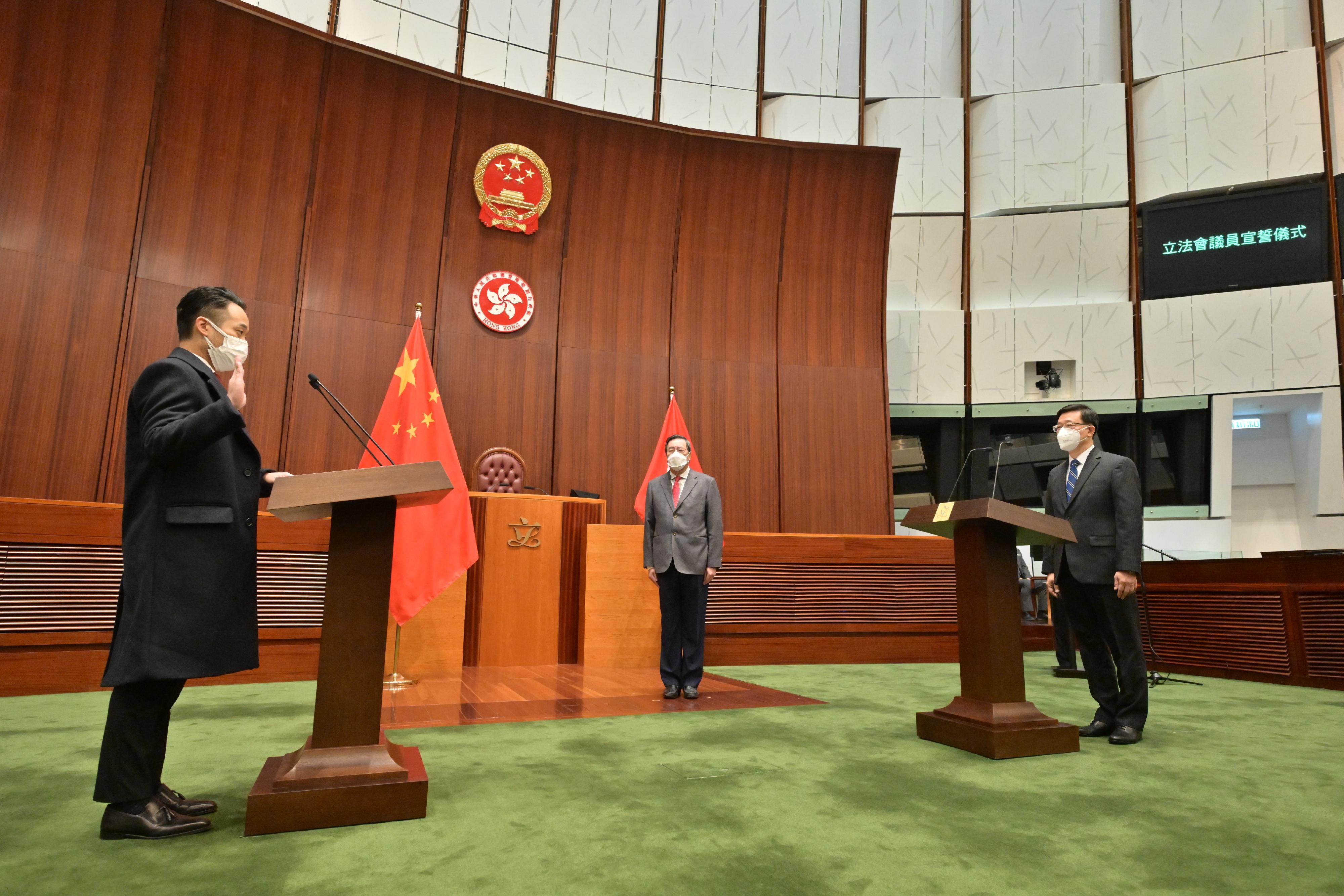 The Chief Executive, Mr John Lee, administers the oath-taking of the four elected members returned by the 2022 Legislative Council (LegCo) Election Committee constituency by-election at the Chamber of the LegCo Complex this morning (December 19). Photos shows Mr Lee (right) administering the oath-taking of Mr Adrian Pedro Ho King-hong (left).