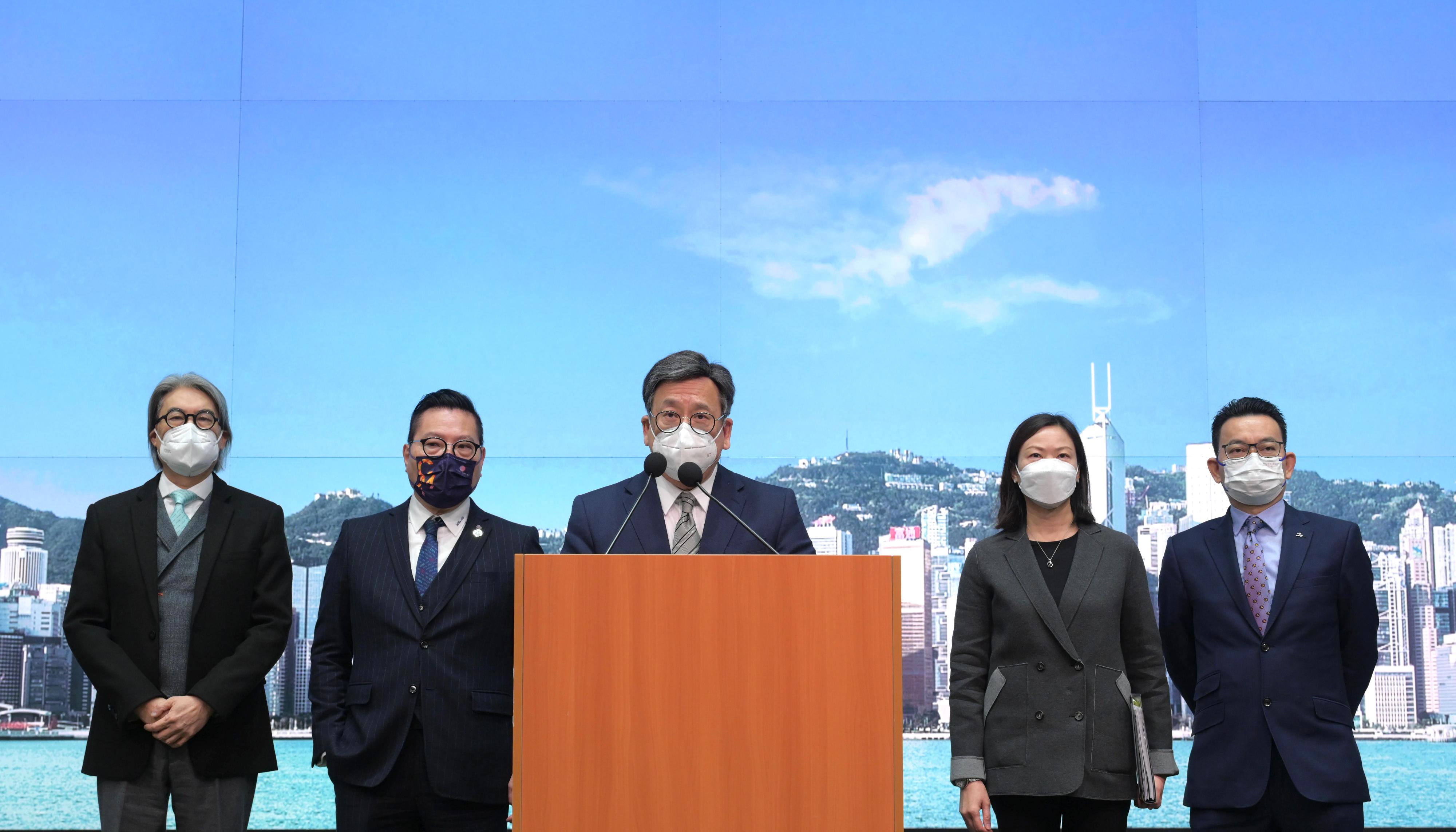 The Secretary for Commerce and Economic Development, Mr Algernon Yau (centre), meets the media today (December 22) on the ruling made by the panel established under the World Trade Organization's Dispute Settlement Body on the origin marking requirement imposed on Hong Kong products by the United States.