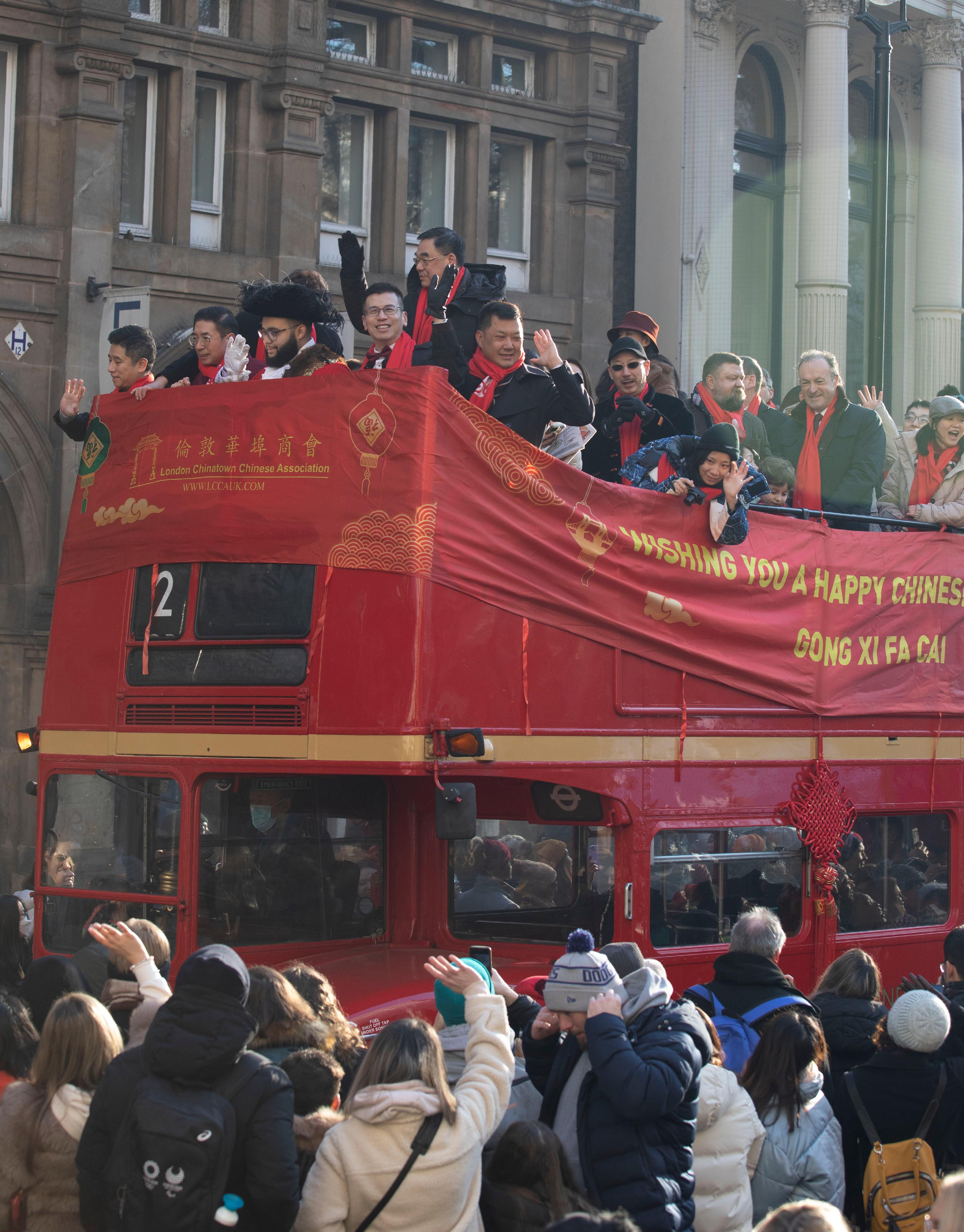 The Hong Kong Economic and Trade Office, London (London ETO) participated in a large-scale London Chinatown celebration in Trafalgar Square, Chinatown and Charing Cross Road on January 22 (London time). Photo shows the Director-General of the London ETO, Mr Gilford Law (fourth left), greeting the crowd in London from an open-air double decker bus in the celebration parade.