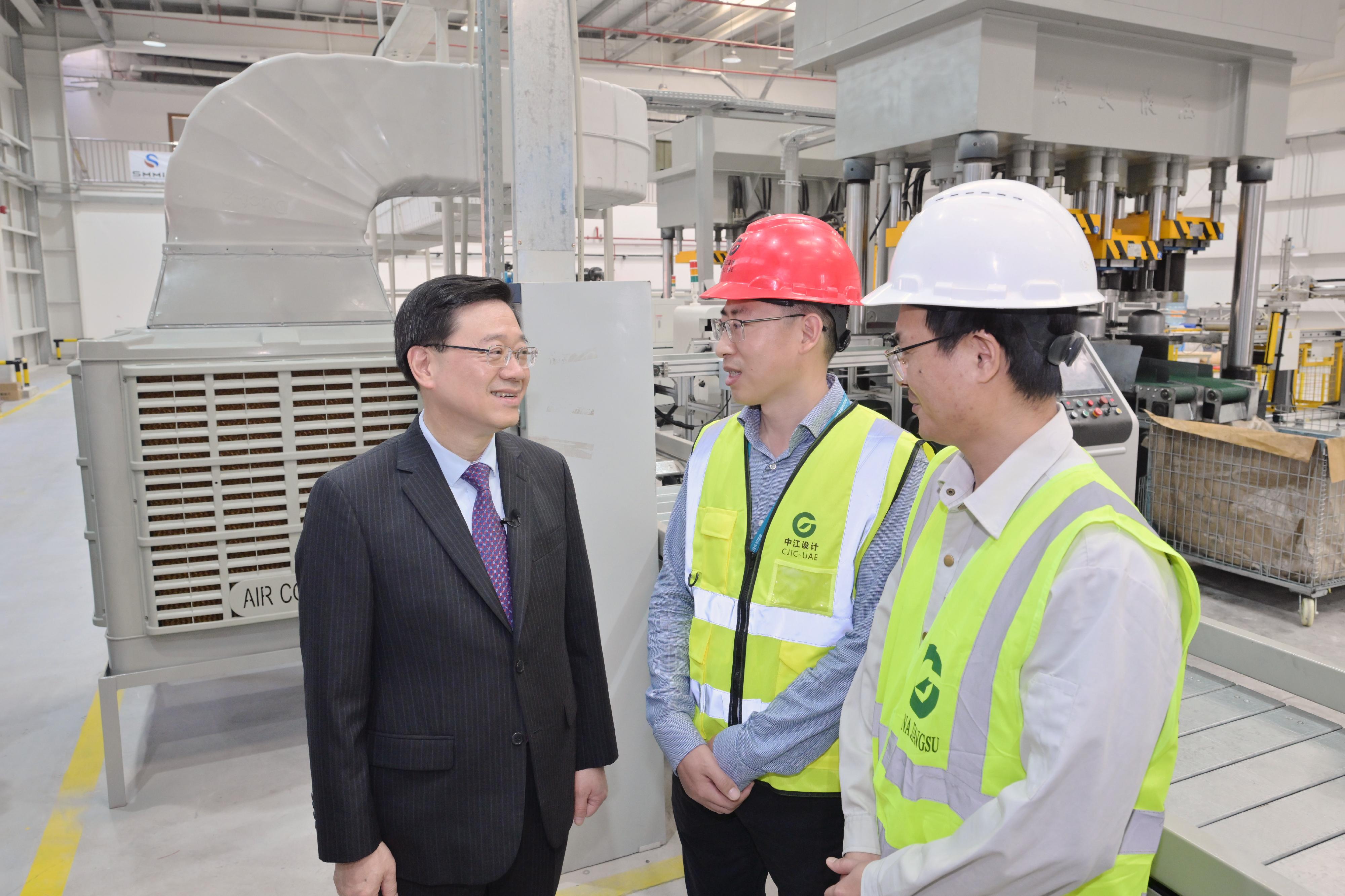 The Chief Executive, Mr John Lee, toured the China-UAE Industrial Capacity Cooperation Demonstration Zone at the Khalifa Industrial Zone in Abu Dhabi, the United Arab Emirates, today (February 8, Abu Dhabi time). Photo shows Mr Lee (first left) talking to staff of the zone to learn about their lives there.