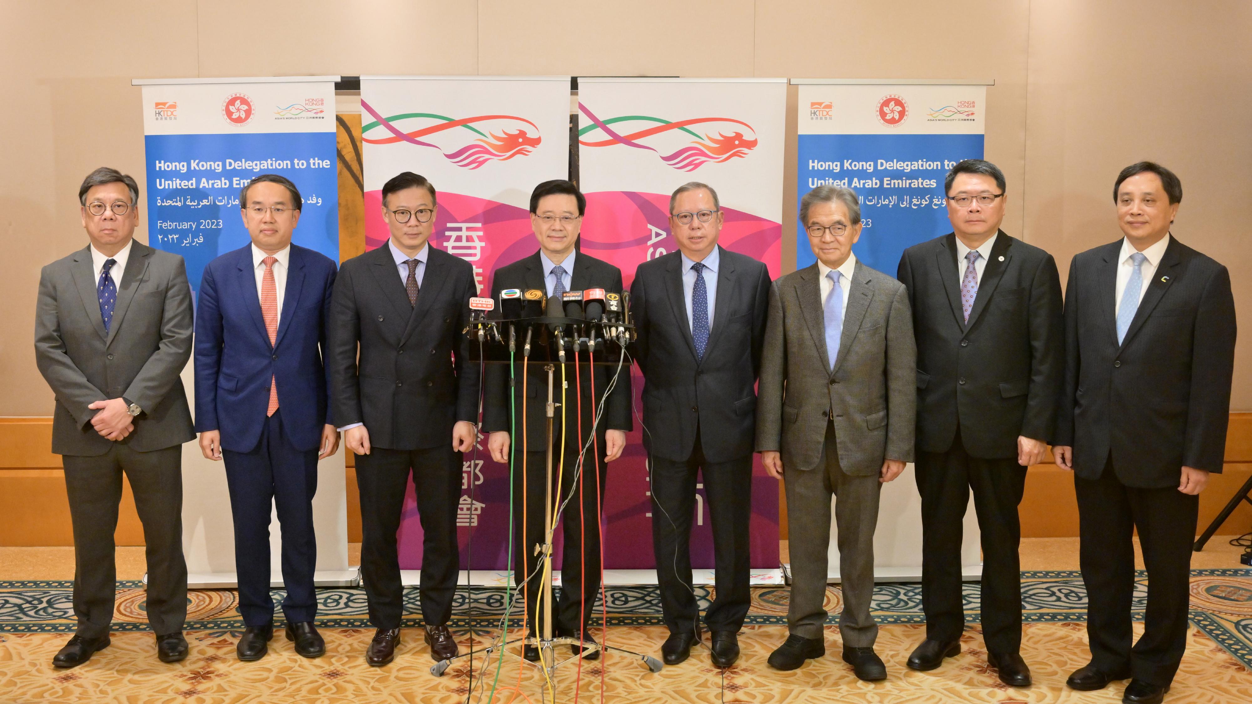 The Chief Executive, Mr John Lee (fourth left), together with the Deputy Secretary for Justice, Mr Cheung Kwok-kwan (third left); the Secretary for Financial Services and the Treasury, Mr Christopher Hui (second left); the Secretary for Commerce and Economic Development, Mr Algernon Yau (first left); the Chairman of the Hong Kong Trade Development Council, Dr Peter Lam (fourth right); the Chairman of the Airport Authority Hong Kong, Mr Jack So (third right); the Chairman of the Hong Kong Science and Technology Parks Corporation and the Chairman of the Federation of Hong Kong Industries, Dr Sunny Chai (second right); and the Chairman of the Hong Kong Cyberport Management Company Limited, Mr Simon Chan (first right), meet the media in Dubai, the United Arab Emirates, today (February 10, Dubai time).