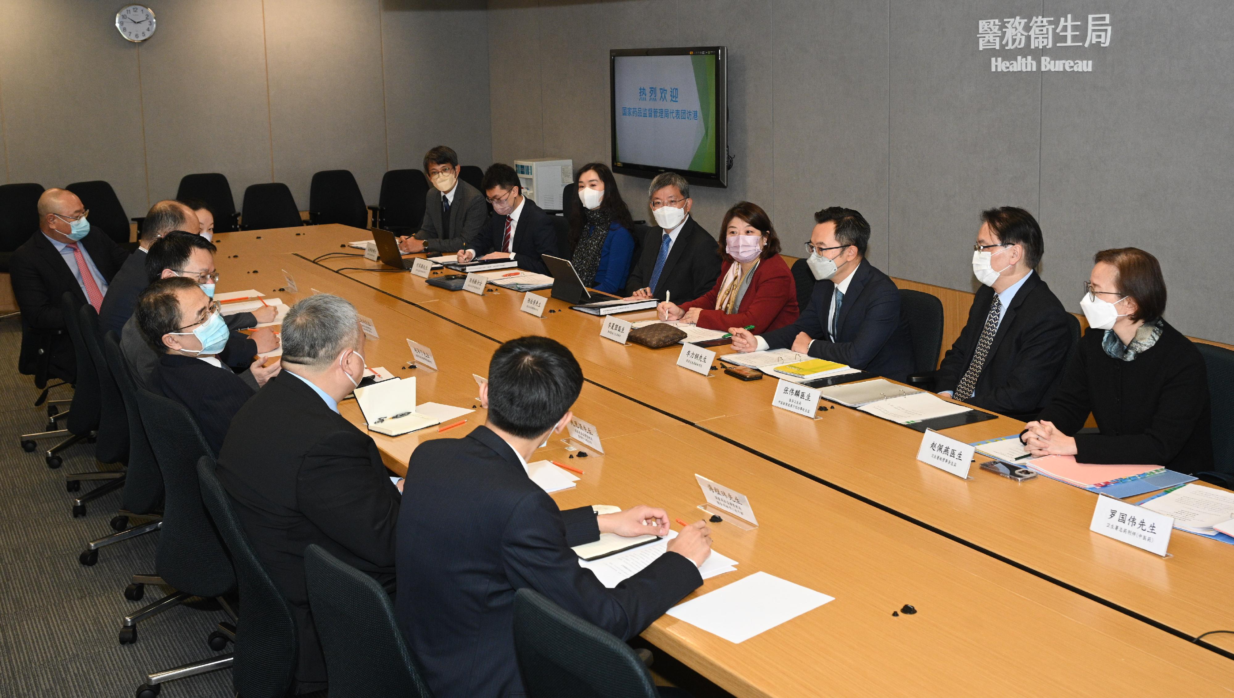 The Acting Secretary for Health, Dr Libby Lee (fourth right), and officers from the Health Bureau met with a delegation of the National Medical Products Administration led by its Member of the Leading Party Members Group and Deputy Commissioner Mr Zhao Junning (fourth left) at the Central Government Offices today (February 13).