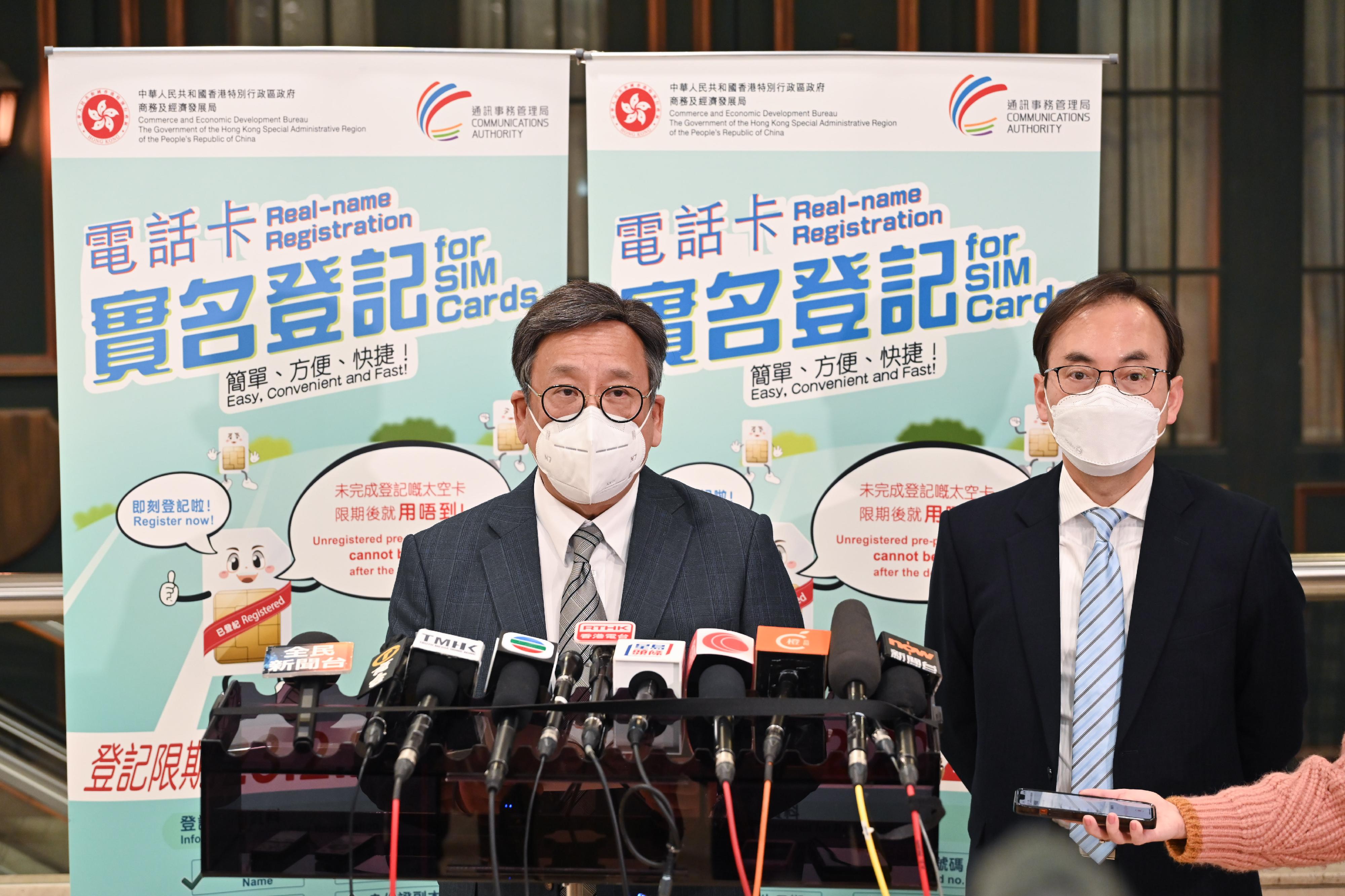 The Secretary for Commerce and Economic Development, Mr Algernon Yau (left), met the media this afternoon (February 16) after visiting Wan Chai Post Office to view the operation of the support service for real-name registration for SIM cards. Looking on is the Director-General of Communications, Mr Chaucer Leung.