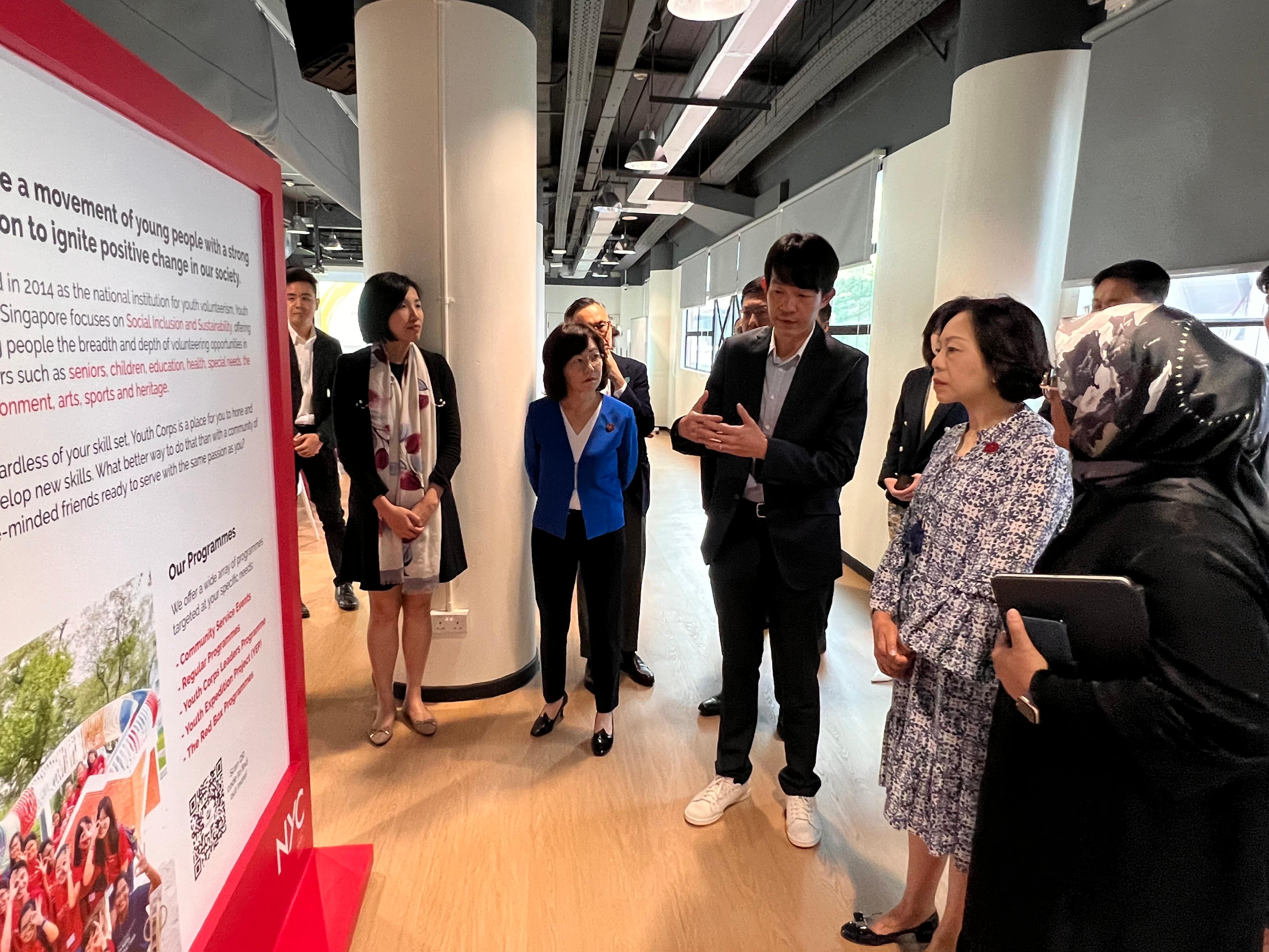 The Secretary for Home and Youth Affairs, Miss Alice Mak, continued her visit in Singapore today (February 17). Photo shows the Deputy Chief Executive of the National Youth Council, Mr Tan Lin Teck (third right), introducing their works to Miss Mak (second right) and the Director of Home Affairs, Mrs Alice Cheung (third left).